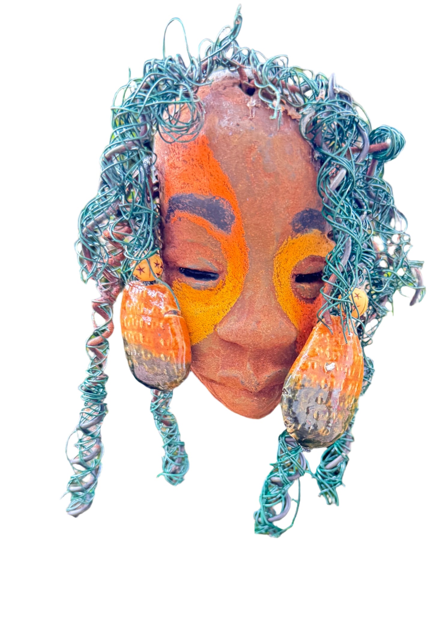 Adda's unique design against a mossy tree bark backdrop is sure to catch your eye. This 3” x 5” 6oz. mixed media raku fire mask, crafted with 15 feet of 24 and 16 gauge wire, adds a touch of elegance to your HerDew mask collection. With a copper nose ring, three-colored complexion, and a large Raku fired earring with two wooden beads, Adda is a must-have for any mask enthusiast.
