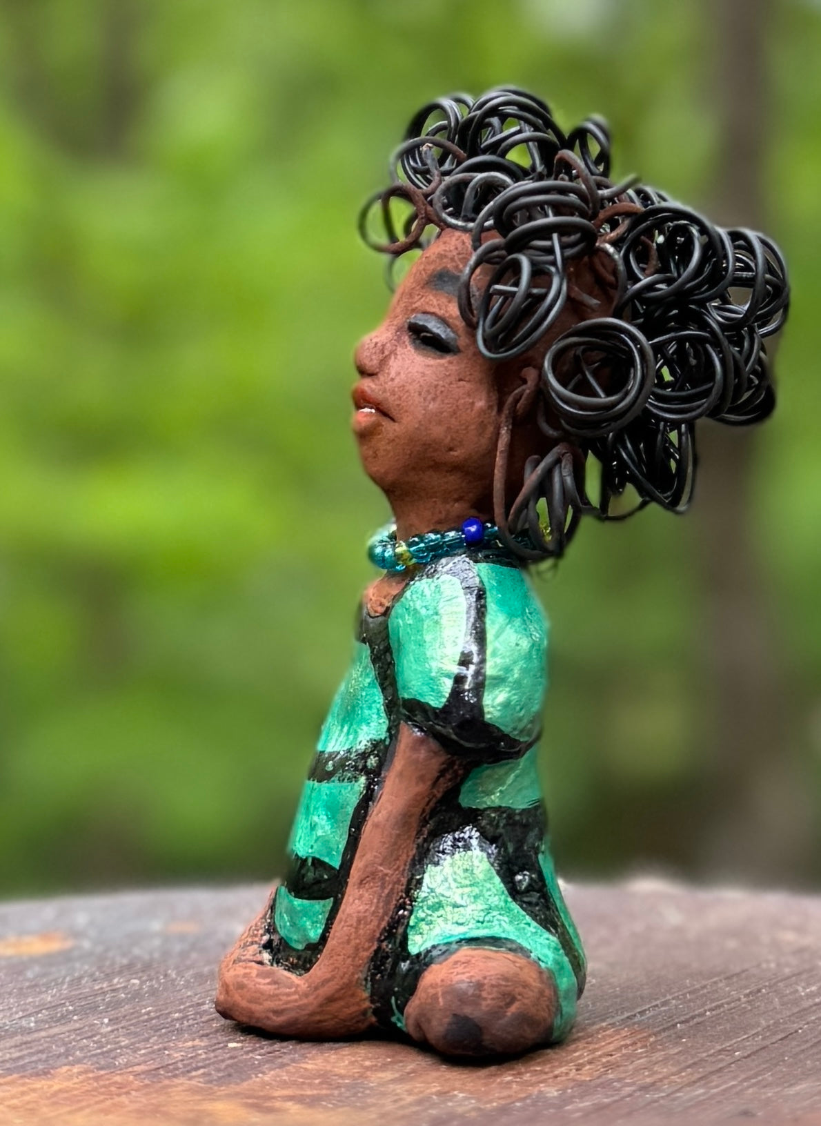 Meet Anza, the brave figurine standing at 6" x 4" x 3" and weighing only 10 ozs. Adorned in a striking striped dress and with her hair styled in a regal coil, Anza represents adventure and determination as she relaxes in a yoga pose, exuding curiosity. Join the Herdew Collection today for the rush of free shipping and our easy return policy. Don't let this unique piece slip away!