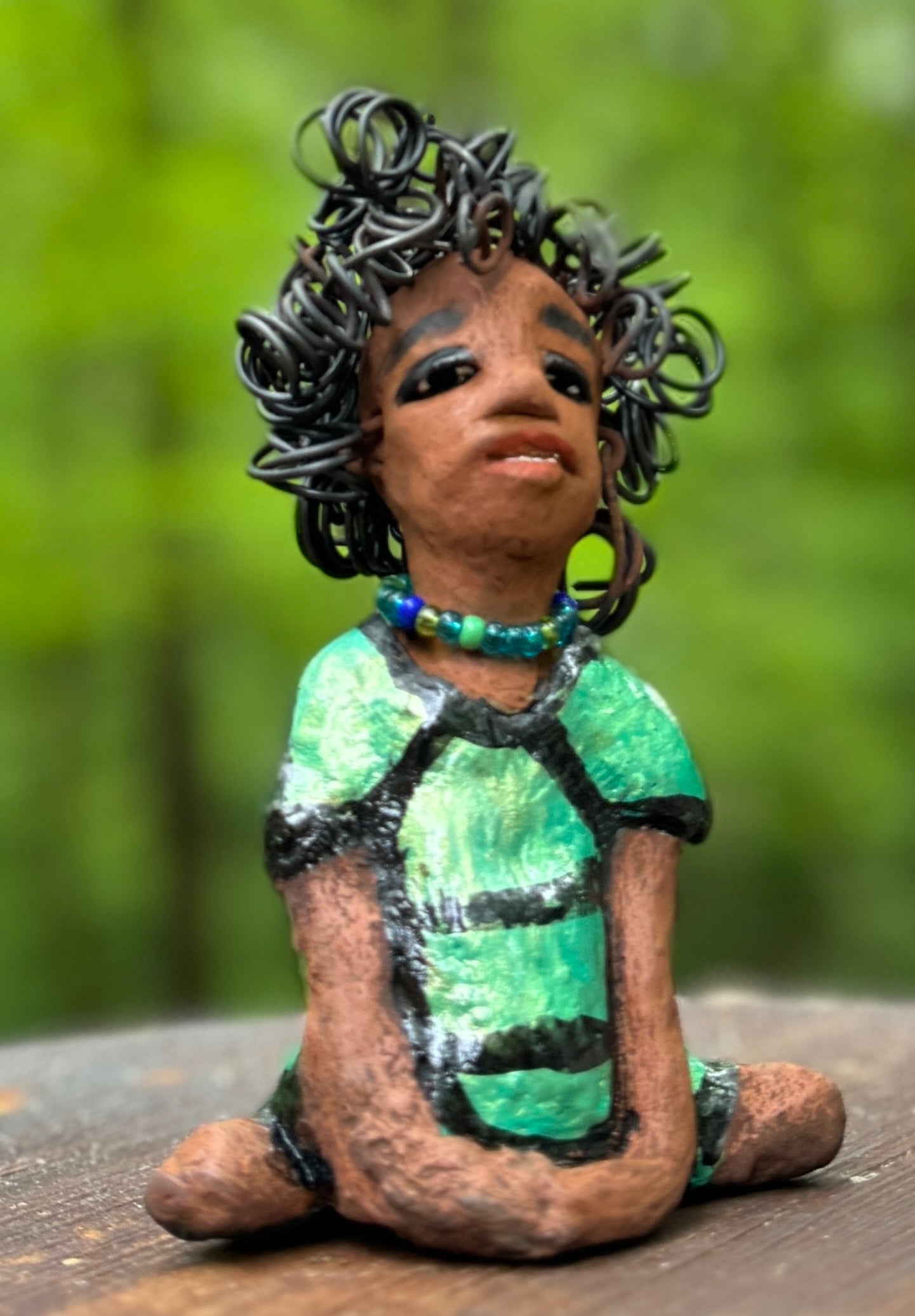 Meet Anza, the brave figurine standing at 6" x 4" x 3" and weighing only 10 ozs. Adorned in a striking striped dress and with her hair styled in a regal coil, Anza represents adventure and determination as she relaxes in a yoga pose, exuding curiosity. Join the Herdew Collection today for the rush of free shipping and our easy return policy. Don't let this unique piece slip away!