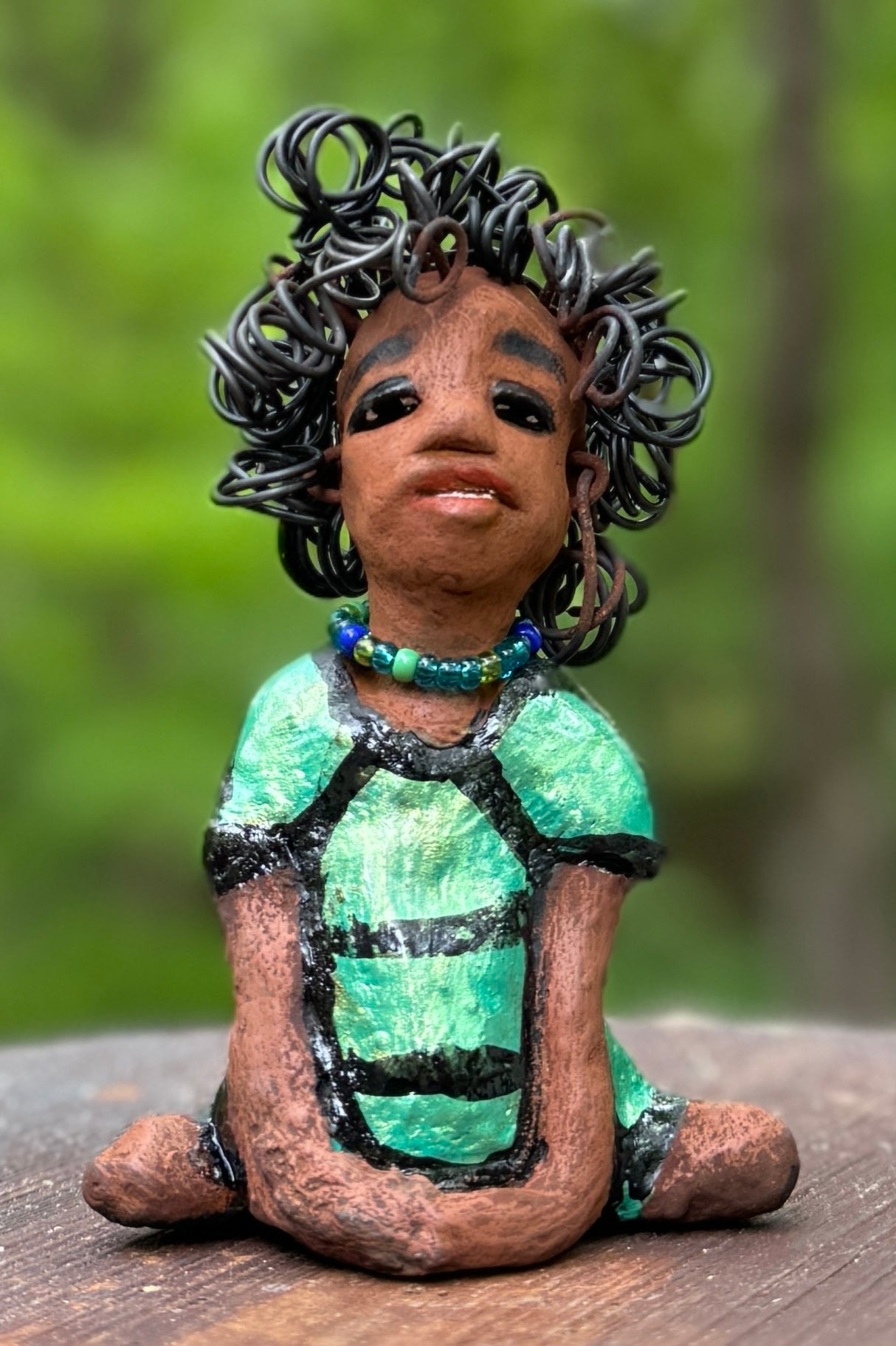 Meet Anza, the brave figurine standing at 6" x 4" x 3" and weighing only 10 ozs. Adorned in a striking striped dress and with her hair styled in a regal coil, Anza represents adventure and determination as she relaxes in a yoga pose, exuding curiosity. Join the Herdew Collection today for the rush of free shipping and our easy return policy. Don't let this unique piece slip away!