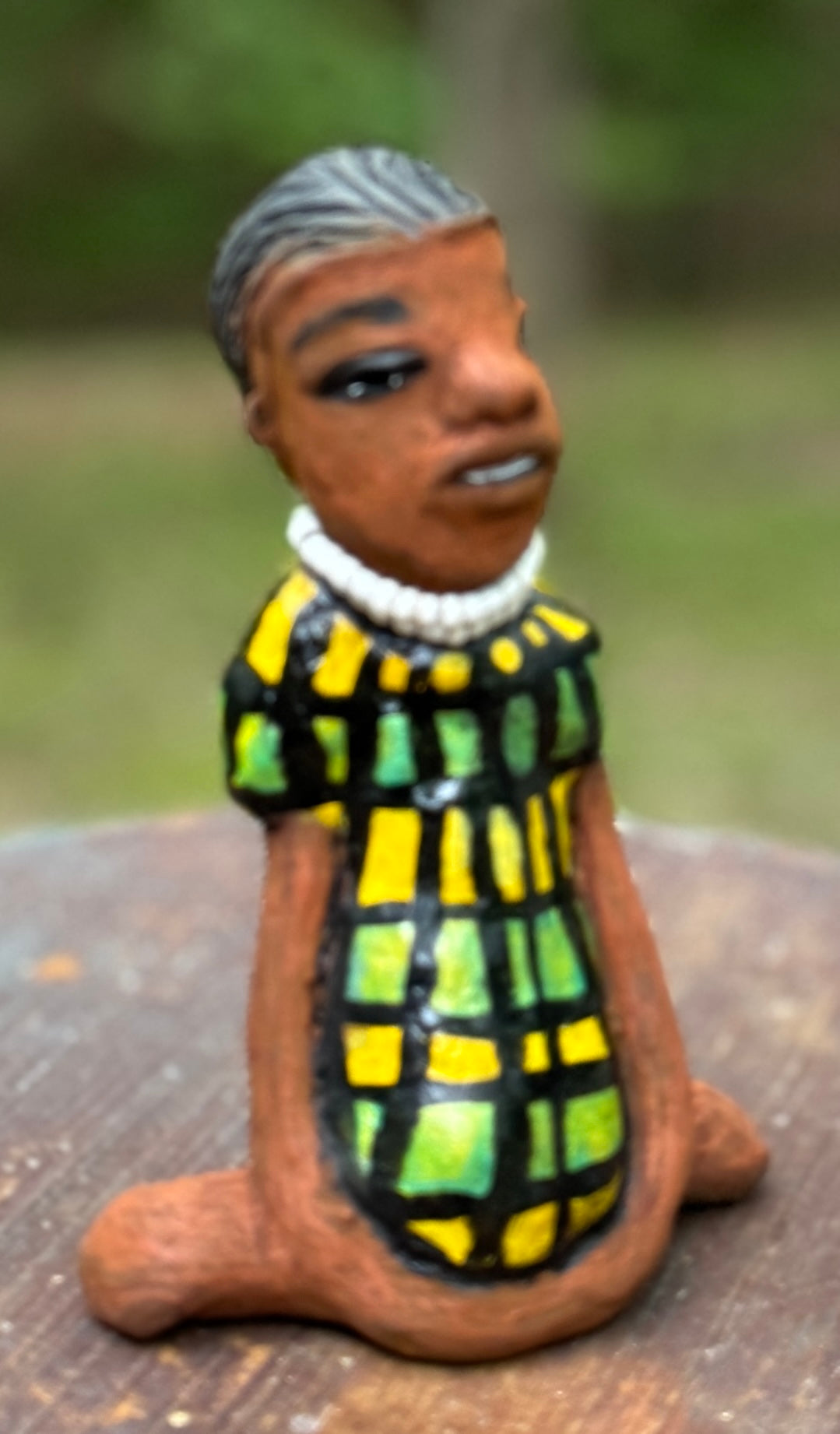 <p>Experience the bold and fearless Efia from the Herdew Collection! This raku fired sculpture stands tall at 6" x 4" x 3" and weighs a brave 10.44 ozs. Clothed in a striking yellow and green dress, Efia's coiled wire hair stretches over 1 foot. With confident outstretched arms, she strikes a yoga pose. Begin your collection with the captivating Efia and embrace adventure!</p> <p> </p>