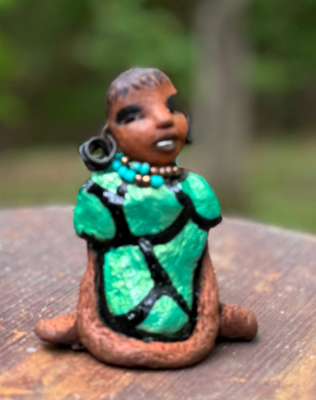 Discover Nala, the bold figurine standing at 4.5" tall and weighing only 5.6 ozs, adorned in a striking black and green African print dress. With her hair styled in coils and her hands calmly resting under her head in a yoga pose, Nala emanates confidence. Join the Herdew Collection and embark on an exciting journey with our complimentary shipping and customer-friendly return policy. Don't hesitate to claim this unique treasure!