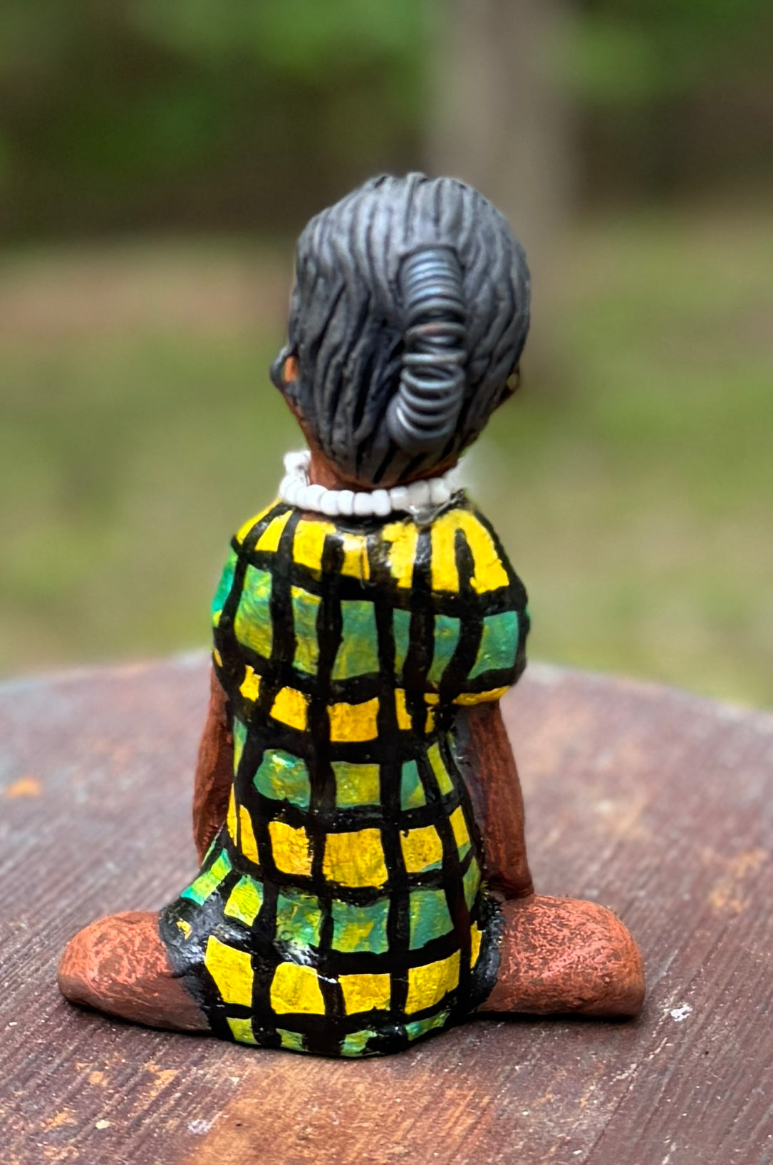 <p>Experience the bold and fearless Efia from the Herdew Collection! This raku fired sculpture stands tall at 6" x 4" x 3" and weighs a brave 10.44 ozs. Clothed in a striking yellow and green dress, Efia's coiled wire hair stretches over 1 foot. With confident outstretched arms, she strikes a yoga pose. Begin your collection with the captivating Efia and embrace adventure!</p> <p> </p>