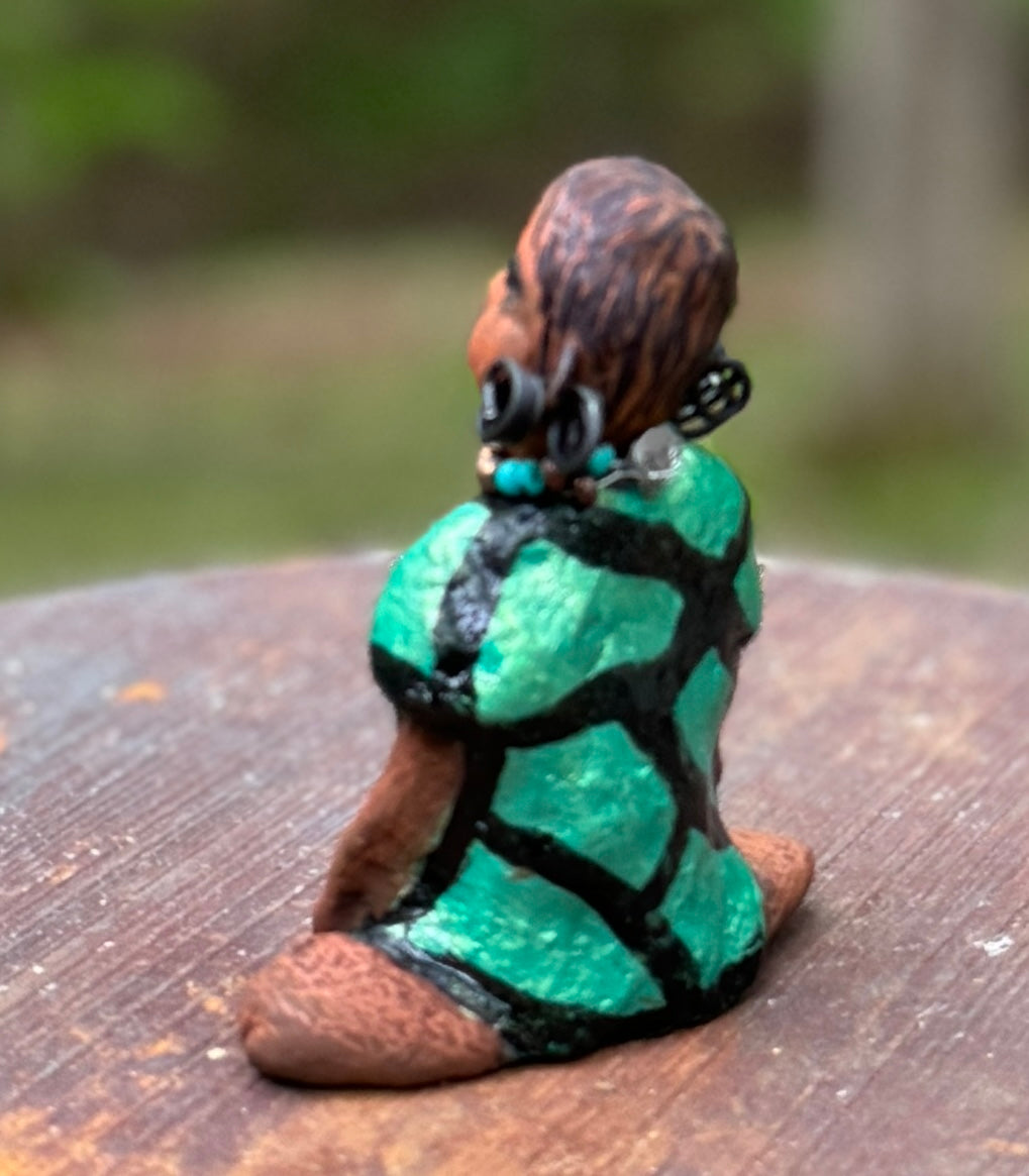 Discover Nala, the bold figurine standing at 4.5" tall and weighing only 5.6 ozs, adorned in a striking black and green African print dress. With her hair styled in coils and her hands calmly resting under her head in a yoga pose, Nala emanates confidence. Join the Herdew Collection and embark on an exciting journey with our complimentary shipping and customer-friendly return policy. Don't hesitate to claim this unique treasure!