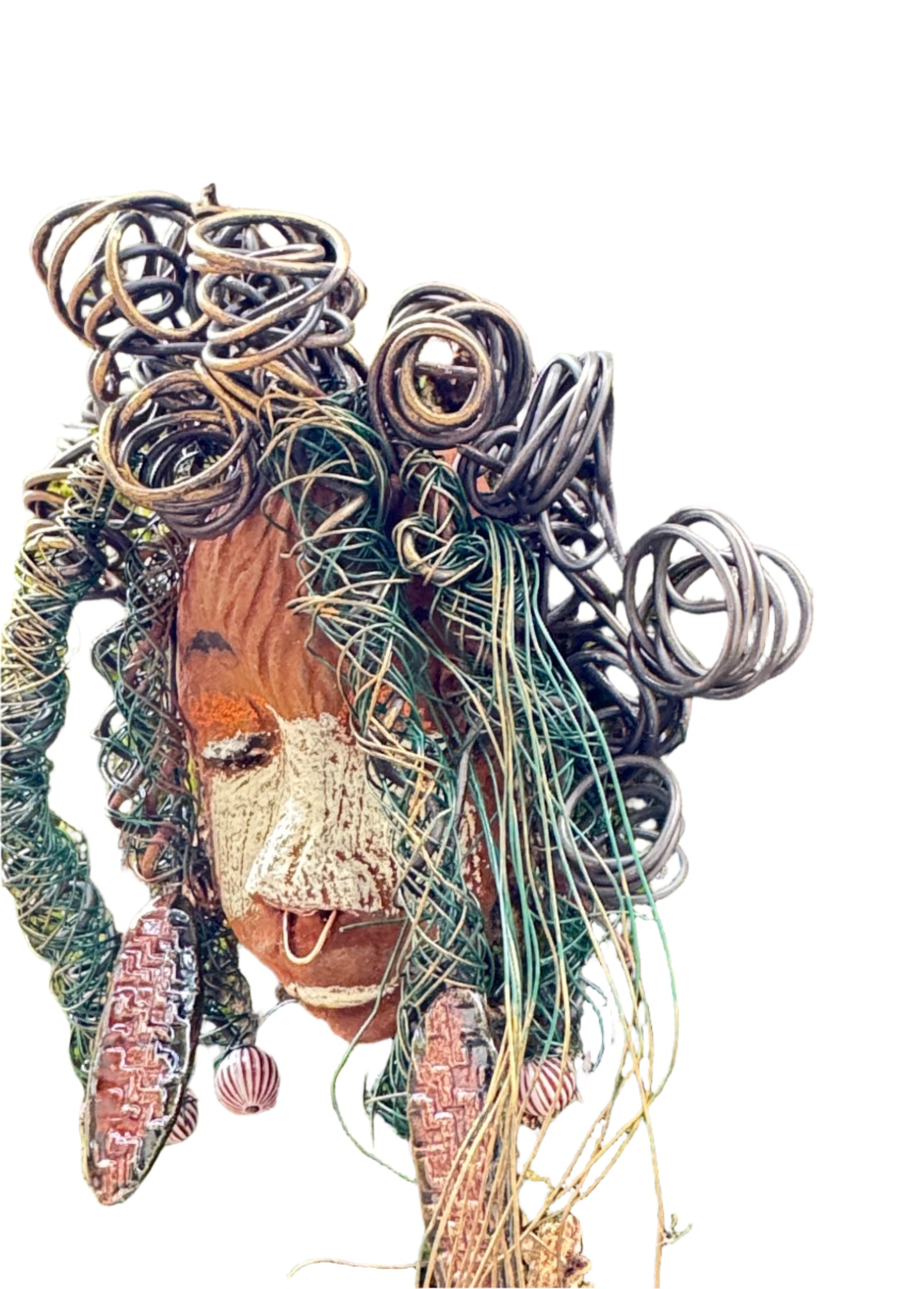 Baldwin Bo is a mixed media raku fire mask, measuring 4" x 6" and weighing 6oz. This unique piece features 25 feet of 24 and 16 gauge wire and a copper nose ring, giving it a three-colored complexion. The mask is also adorned with large Raku fired earrings and a wooden bead, and looks stunning when photographed against a mossy tree bark. Add Baldwin Bo to your collection of HerDew masks for a beautiful and eye-catching addition.