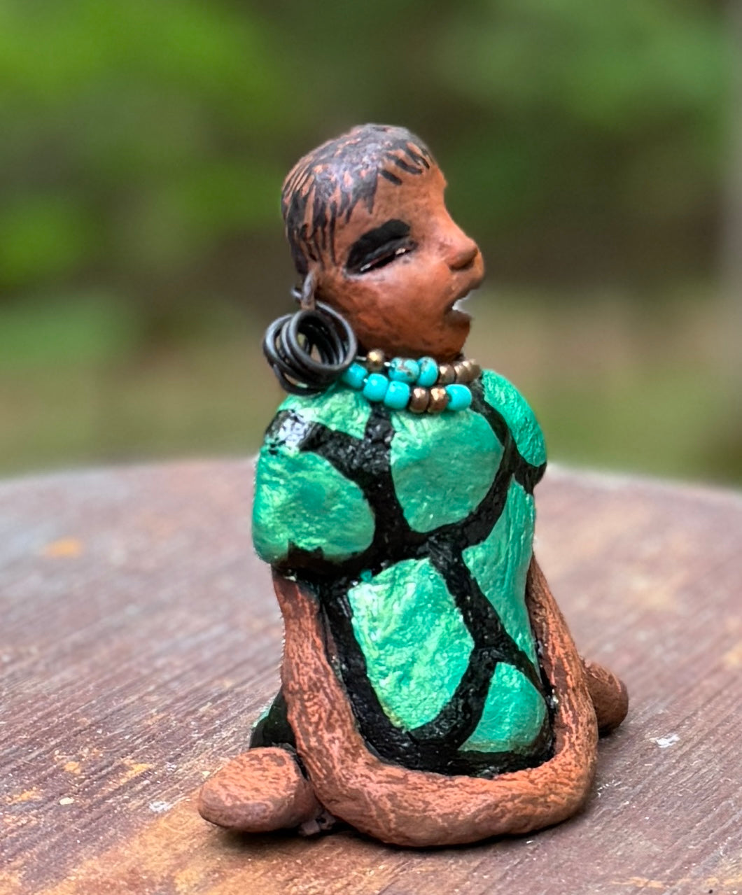 Discover Nala, the bold figurine standing at 4.5" tall and weighing only 5.6 ozs, adorned in a striking black and green African print dress. With her hair styled in coils and her hands calmly resting under her head in a yoga pose, Nala emanates confidence. Join the Herdew Collection and embark on an exciting journey with our complimentary shipping and customer-friendly return policy. Don't hesitate to claim this unique treasure!