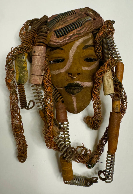 Weighing 6 oz and with a diameter of 5" by 8",  Addo adds mystic to any wall, tree or shadowbox. His earthy braids, honey brown complexion and dark lips make him the perfect first piece from the HerDew mask collection. Shadow box not included with Jaleni's purchase.