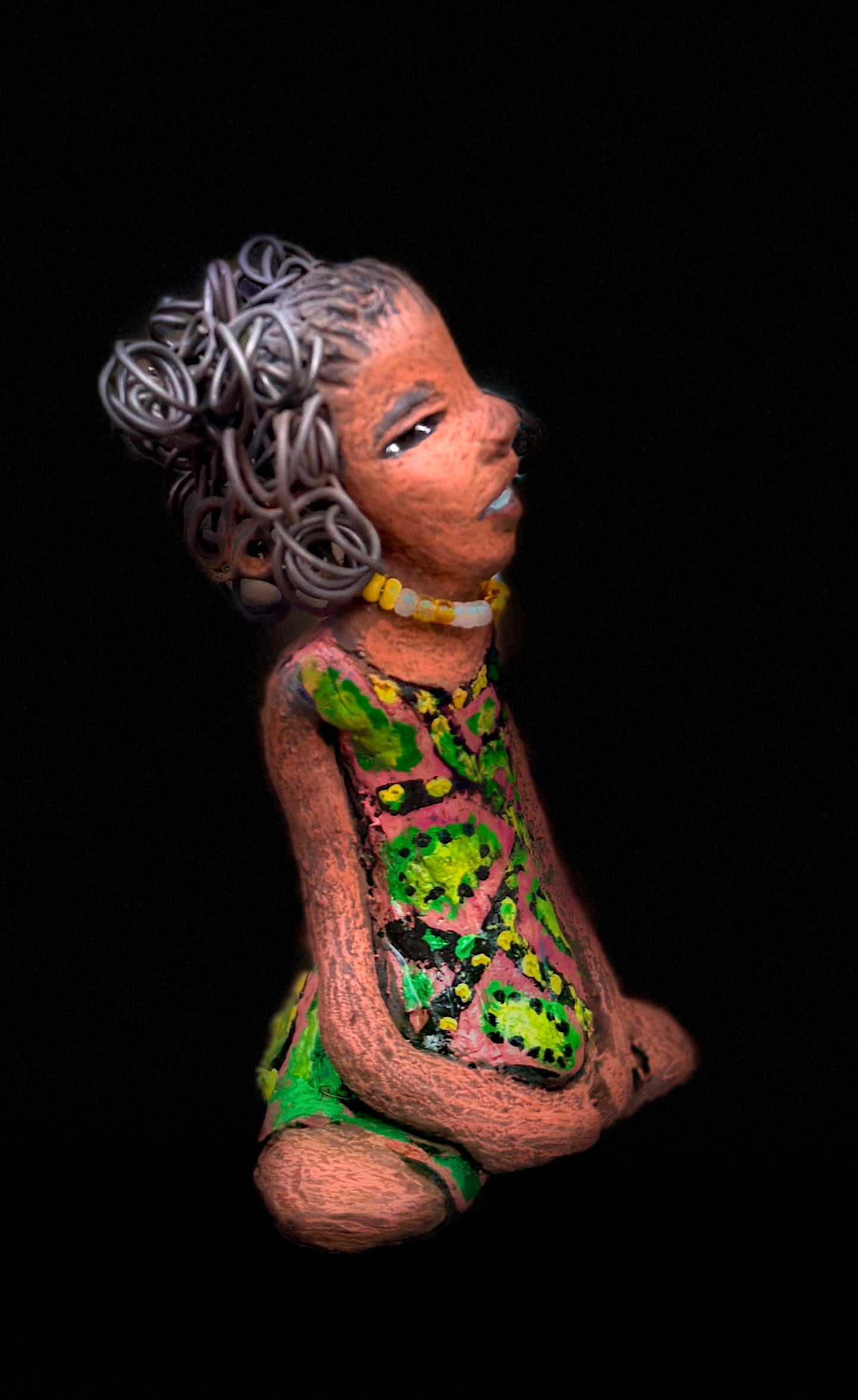 Introducing Katie, the fearless figurine who measures 6" x 4" x 3" and weighs a mere 11 ozs. Donning a stunning speckled red and green dress and with her coiled hair as her crown of glory, Katie exudes confidence and courage as she sits in a yoga pose, exuding curiosity. Begin your journey with the Herdew Collection and experience the thrill of free shipping and our customer-friendly return policy. Don't miss out on this one-of-a-kind piece! <p> </p>