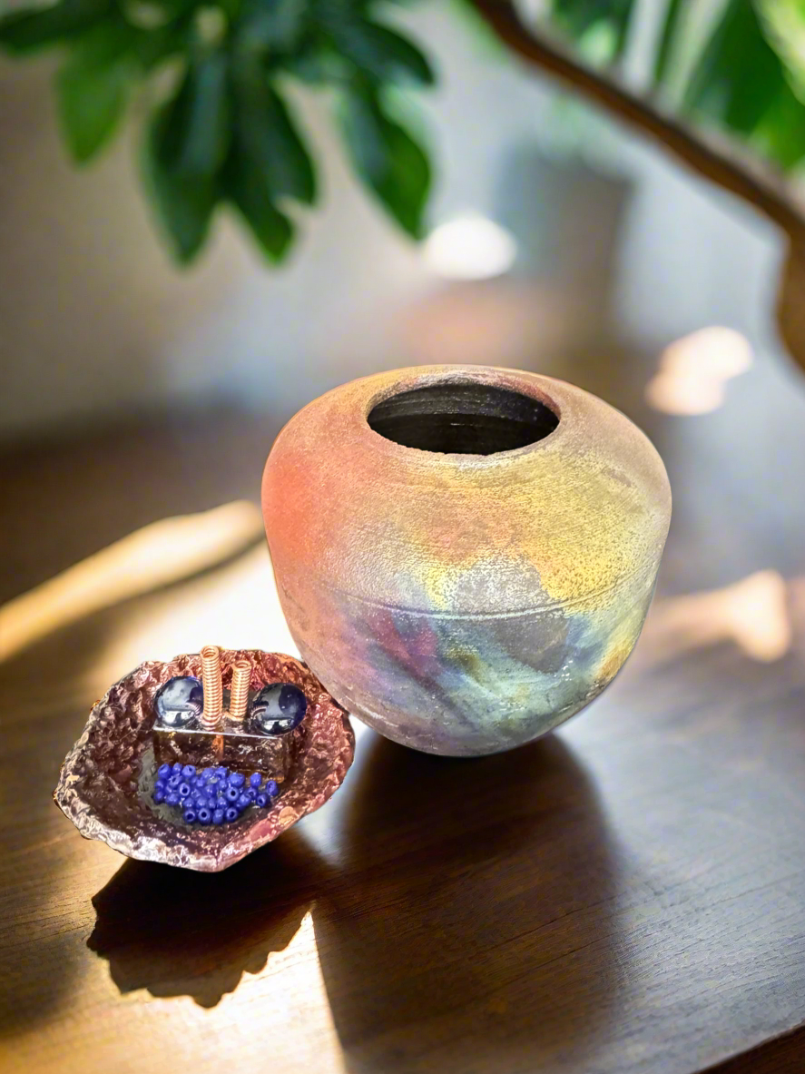 Enhance any room with a natural touch by using the Autumn brown, orange, and gold Earthy Vase with Incense Top -2. At 7 1/2 inches tall, 5 inches wide and deep, and 1 pound and 1 -13 ounces, this vase is perfect for displaying flowers and decorative pieces. Its copper glazed interior adds to its rustic charm, while the 3 and a half inch opening allows for easy arranging. Additionally, the lid doubles as an incense holder.
