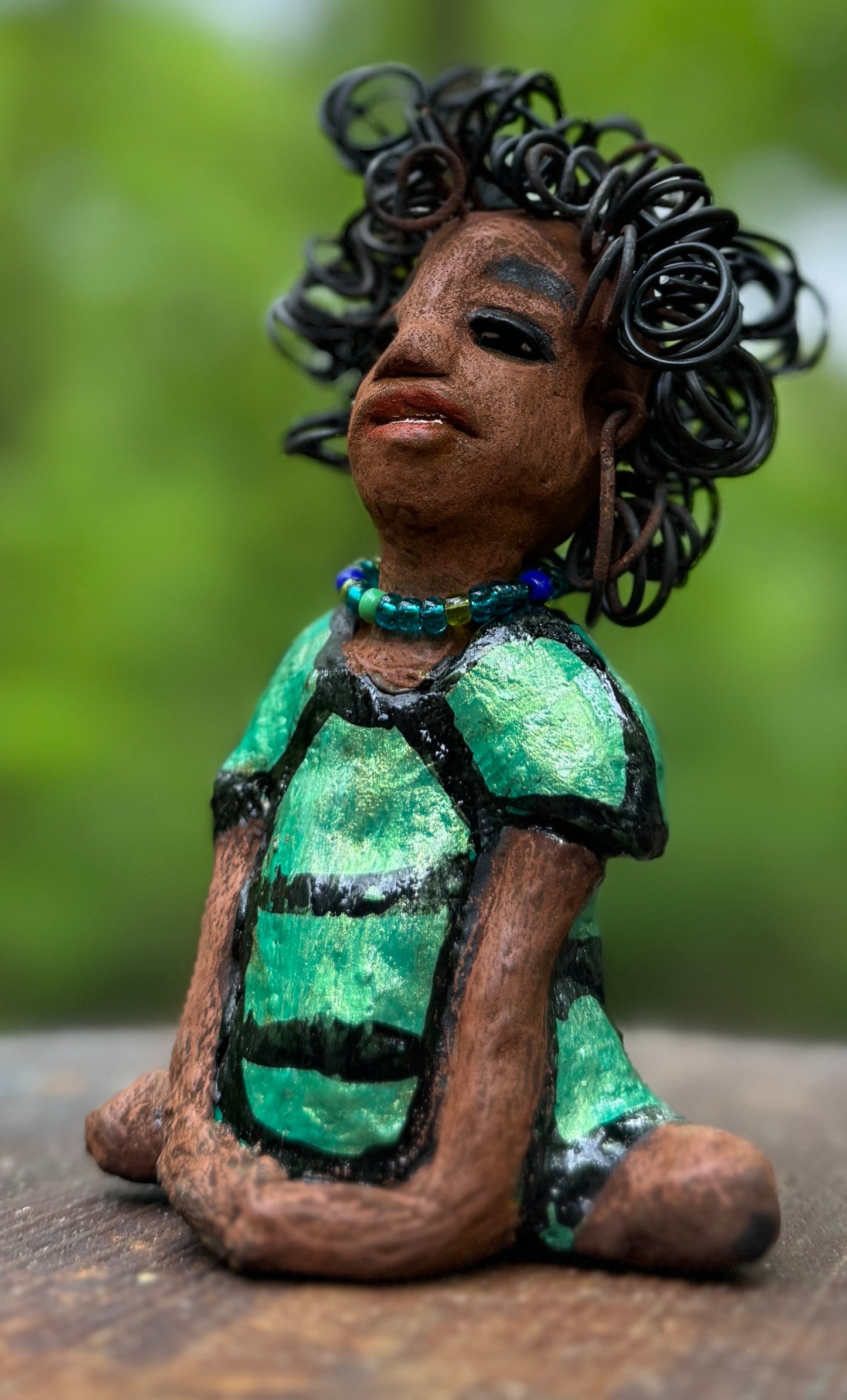 Meet Anza, the brave figurine standing at 6" x 4" x 3" and weighing only 10 ozs. Adorned in a striking striped dress and with her hair styled in a regal coil, Anza represents adventure and determination as she relaxes in a yoga pose, exuding curiosity. Join the Herdew Collection today for the rush of free shipping and our easy return policy. Don't let this unique piece slip away!