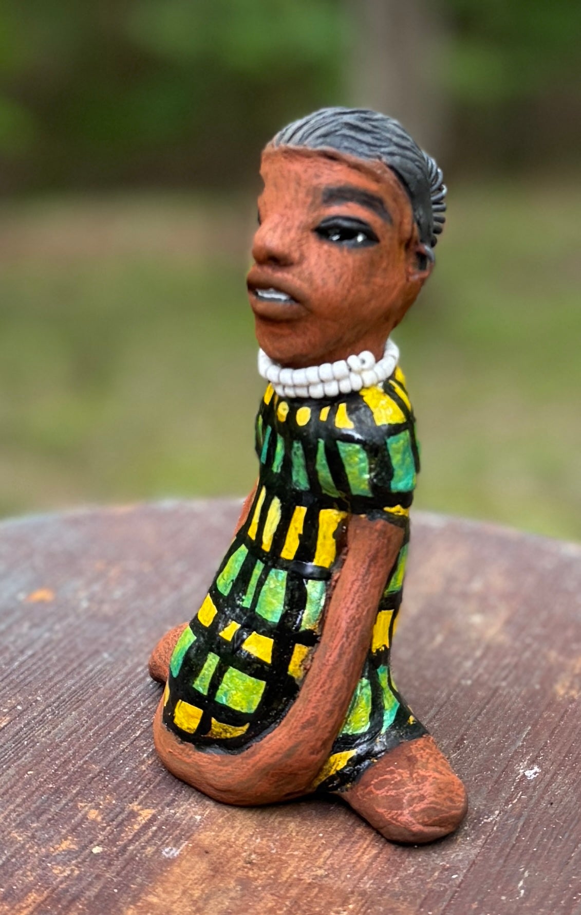 <p>Experience the bold and fearless Efia from the Herdew Collection! This raku fired sculpture stands tall at 6" x 4" x 3" and weighs a brave 10.44 ozs. Clothed in a striking yellow and green dress, Efia's coiled wire hair stretches over 1 foot. With confident outstretched arms, she strikes a yoga pose. Begin your collection with the captivating Efia and embrace adventure!</p> <p> </p>