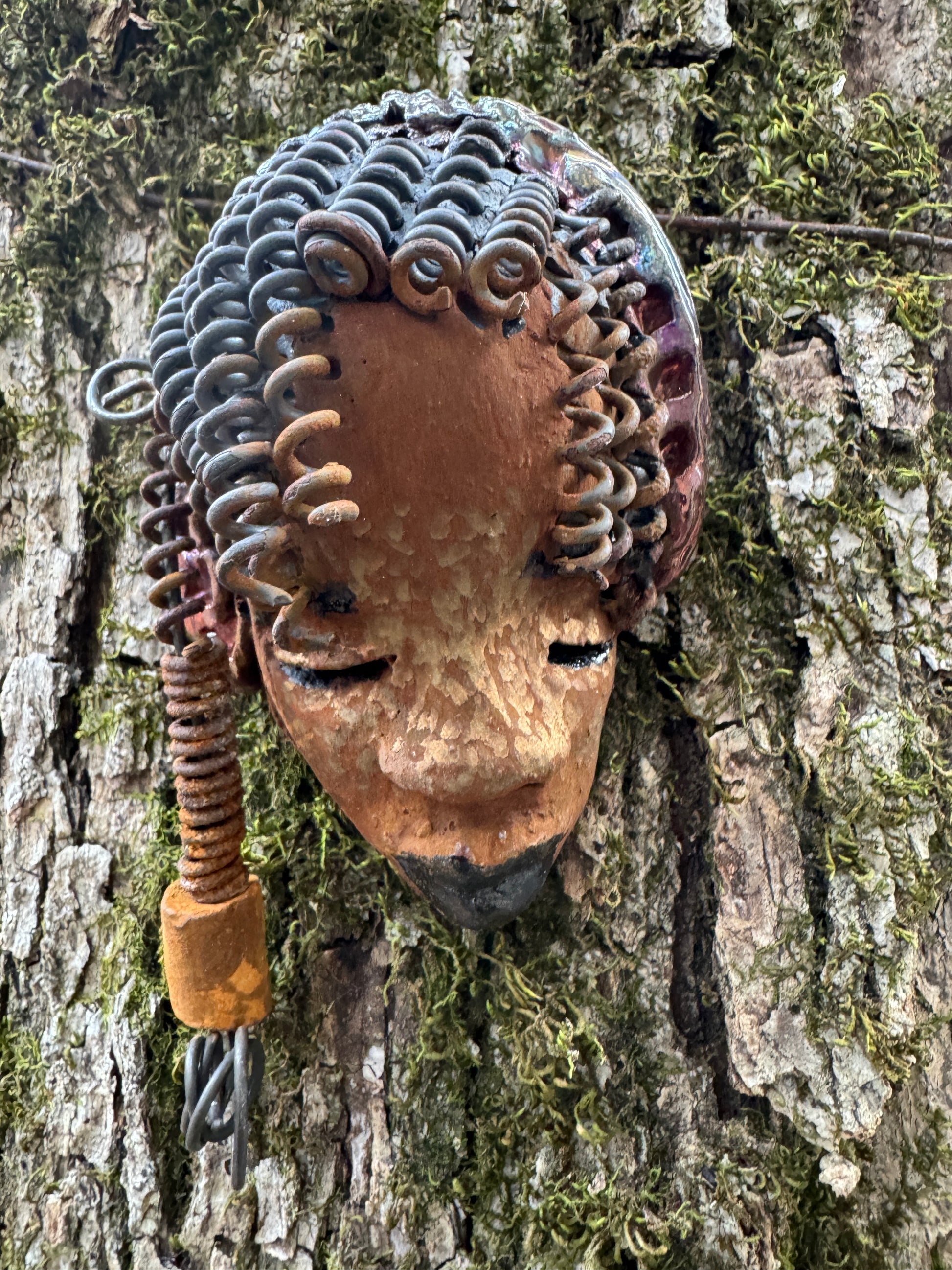 Tricia boasts a beautiful two tone honey-brown complexion, standing 3" x 5" and embellished with coils of wire and hand-made beads. Her hair is graced with hanging twists and was photographed outside amongst the trees. But of course, she will look fantastic no matter where you decide to place her.