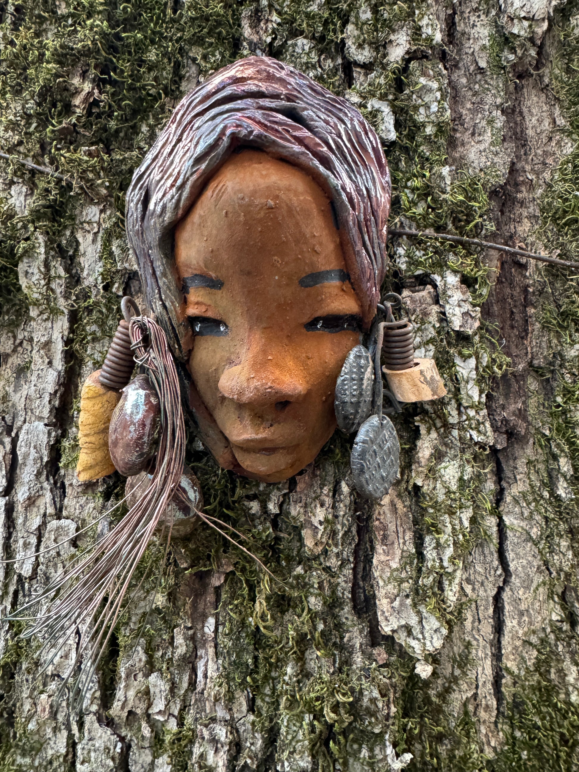 Marci boasts a beautiful honey-brown complexion, standing 5" x 7"  weighs 6.2 ozs. and embellished with coils of wire and hand-made beads. Her hair is graced with a copper glaze and was photographed outside amongst the trees. But of course, she will look fantastic no matter where you decide to place her.