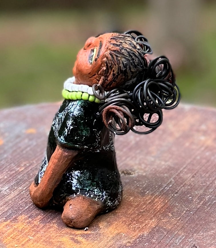 Say hello to Salana, the daring figurine standing at 4.5" x 3.5" x 3" and weighing a mere 8.5 ozs. Adorned in a striking black and white African print dress and with her coiled hair as her crown, Salana exudes boldness with her head held back and bravery as she sits in a yoga pose, radiating confidence. Embark on an adventure with the Herdew Collection and feel the exhilaration of free shipping and our customer-friendly return policy. Don't let this unique piece slip away!