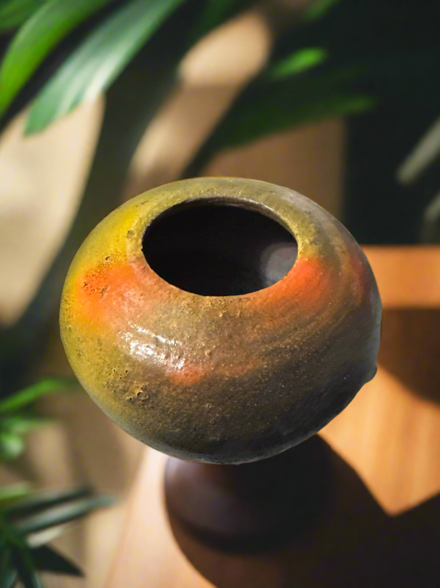 Give any space a touch of nature with the Autumn brown, orange, and gold Earthy Vase with Incense Top -3. Measuring 4 1/2 inches tall, 5 inches wide and deep, and weighing 1 pound and 1 -52 ounces, this vase is ideal for showcasing blooms and accents. Its copper glazed interior enhances its rustic appeal, and the 2-inch opening enables effortless arranging. Furthermore, the top can be used as a holder for incense.