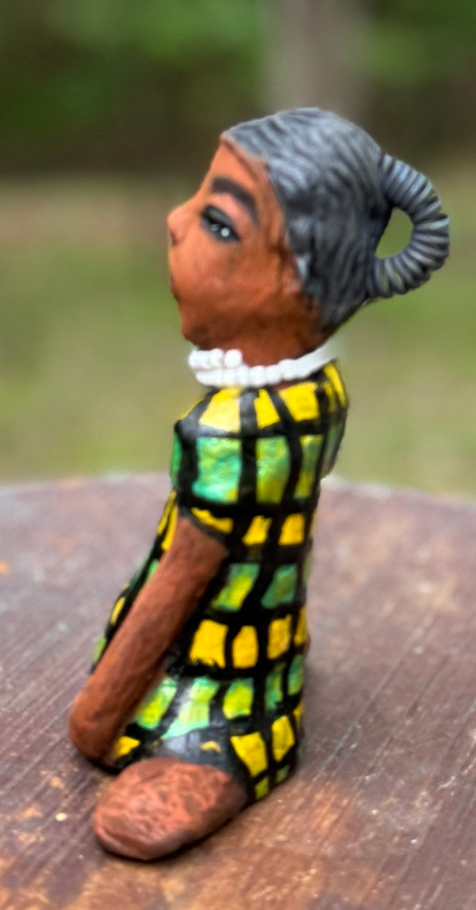 <p>Experience the bold and fearless Efia from the Herdew Collection! This raku fired sculpture stands tall at 6" x 4" x 3" and weighs a brave 10.44 ozs. Clothed in a striking yellow and green dress, Efia's coiled wire hair stretches over 1 foot. With confident outstretched arms, she strikes a yoga pose. Begin your collection with the captivating Efia and embrace adventure!</p> <p> </p>