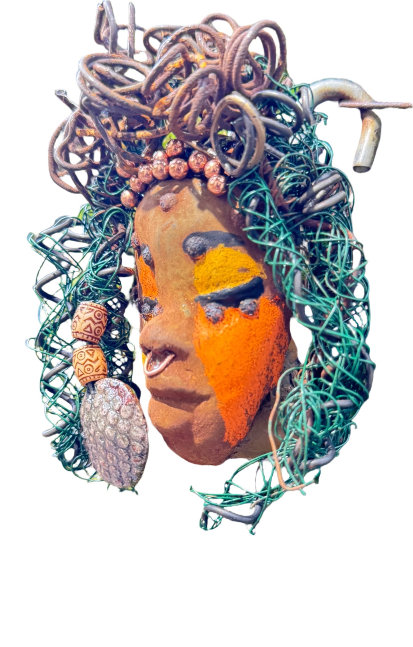 Adda's unique design against a mossy tree bark backdrop is sure to catch your eye. This 3” x 5” 6oz. mixed media raku fire mask, crafted with 15 feet of 24 and 16 gauge wire, adds a touch of elegance to your HerDew mask collection. With a copper nose ring, three-colored complexion, and a large Raku fired earring with two wooden beads, Adda is a must-have for any mask enthusiast.