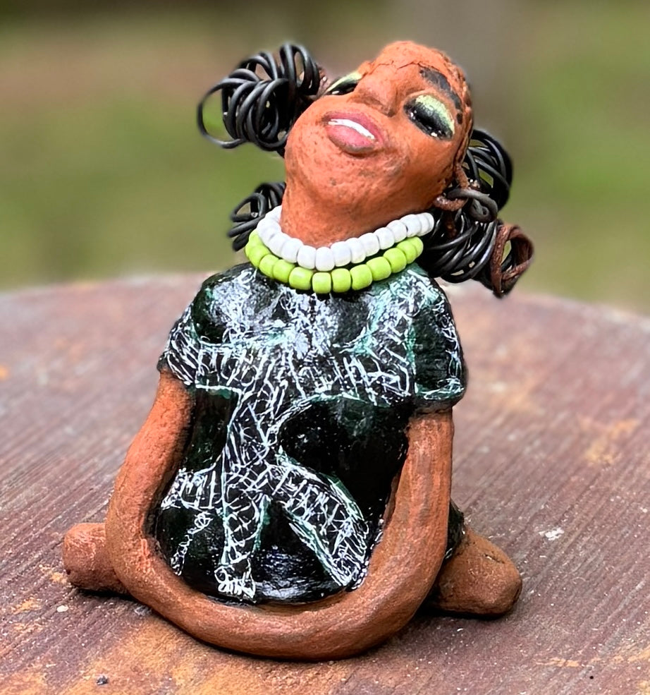 Say hello to Salana, the daring figurine standing at 4.5" x 3.5" x 3" and weighing a mere 8.5 ozs. Adorned in a striking black and white African print dress and with her coiled hair as her crown, Salana exudes boldness with her head held back and bravery as she sits in a yoga pose, radiating confidence. Embark on an adventure with the Herdew Collection and feel the exhilaration of free shipping and our customer-friendly return policy. Don't let this unique piece slip away!