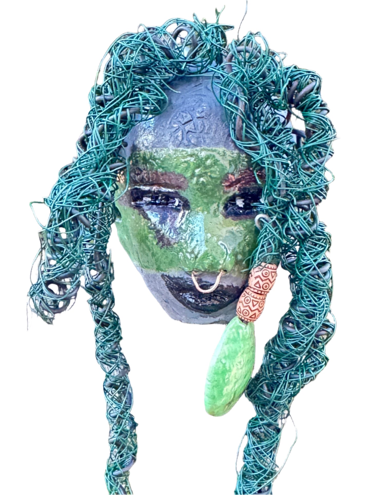 Introducing Nala, a unique raku fire mask made with a stunning mixture of 24 and 16 gauge wire and adorned with detailed blue tribal beads. This 4 x 6" piece features over 15 feet of wire and can be proudly displayed on a solid black or white surface. For a more striking display, try Nala against a backdrop of lush, verdant trees.
