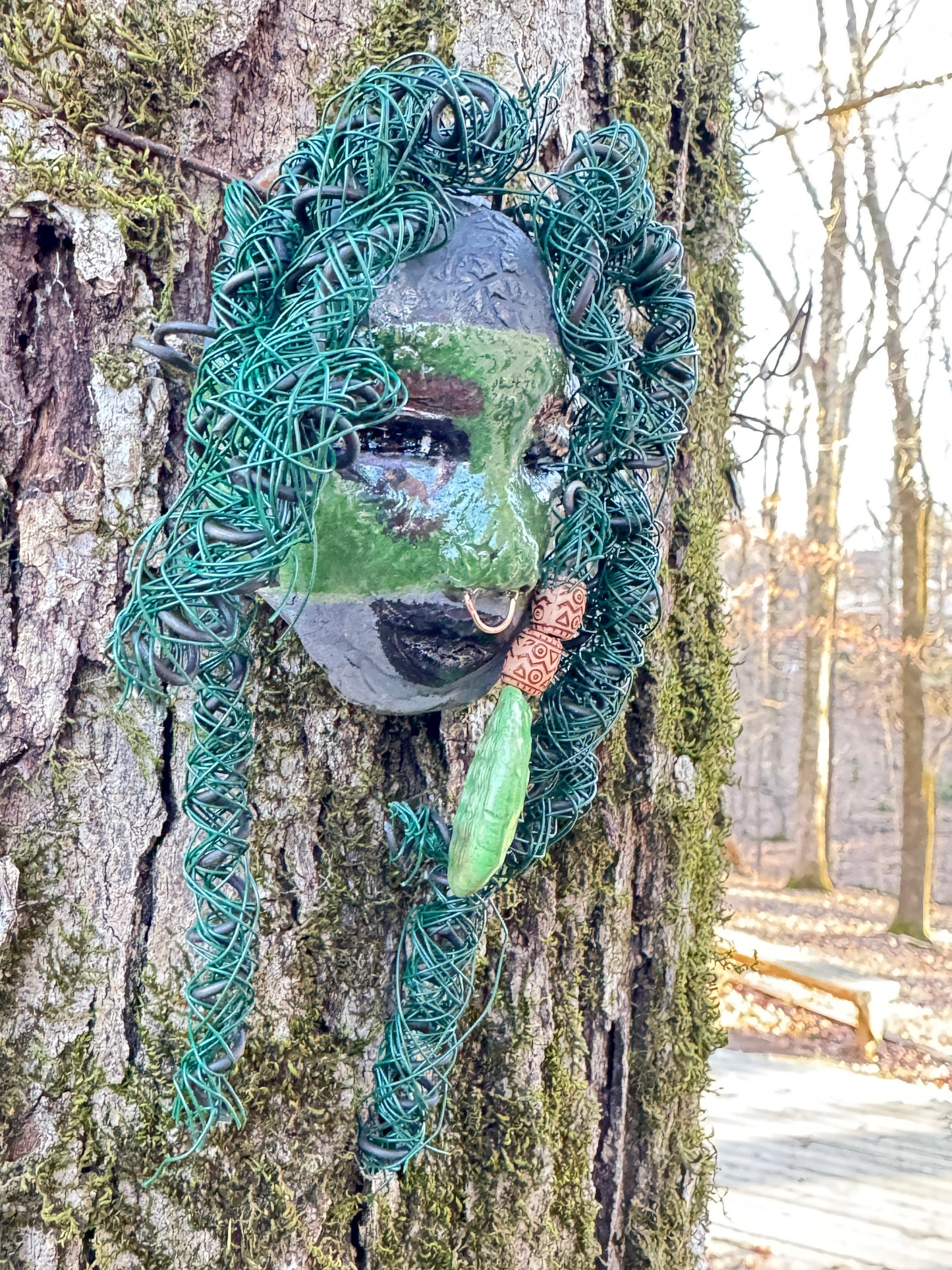 Introducing Nala, a unique raku fire mask made with a stunning mixture of 24 and 16 gauge wire and adorned with detailed blue tribal beads. This 4 x 6" piece features over 15 feet of wire and can be proudly displayed on a solid black or white surface. For a more striking display, try Nala against a backdrop of lush, verdant trees.