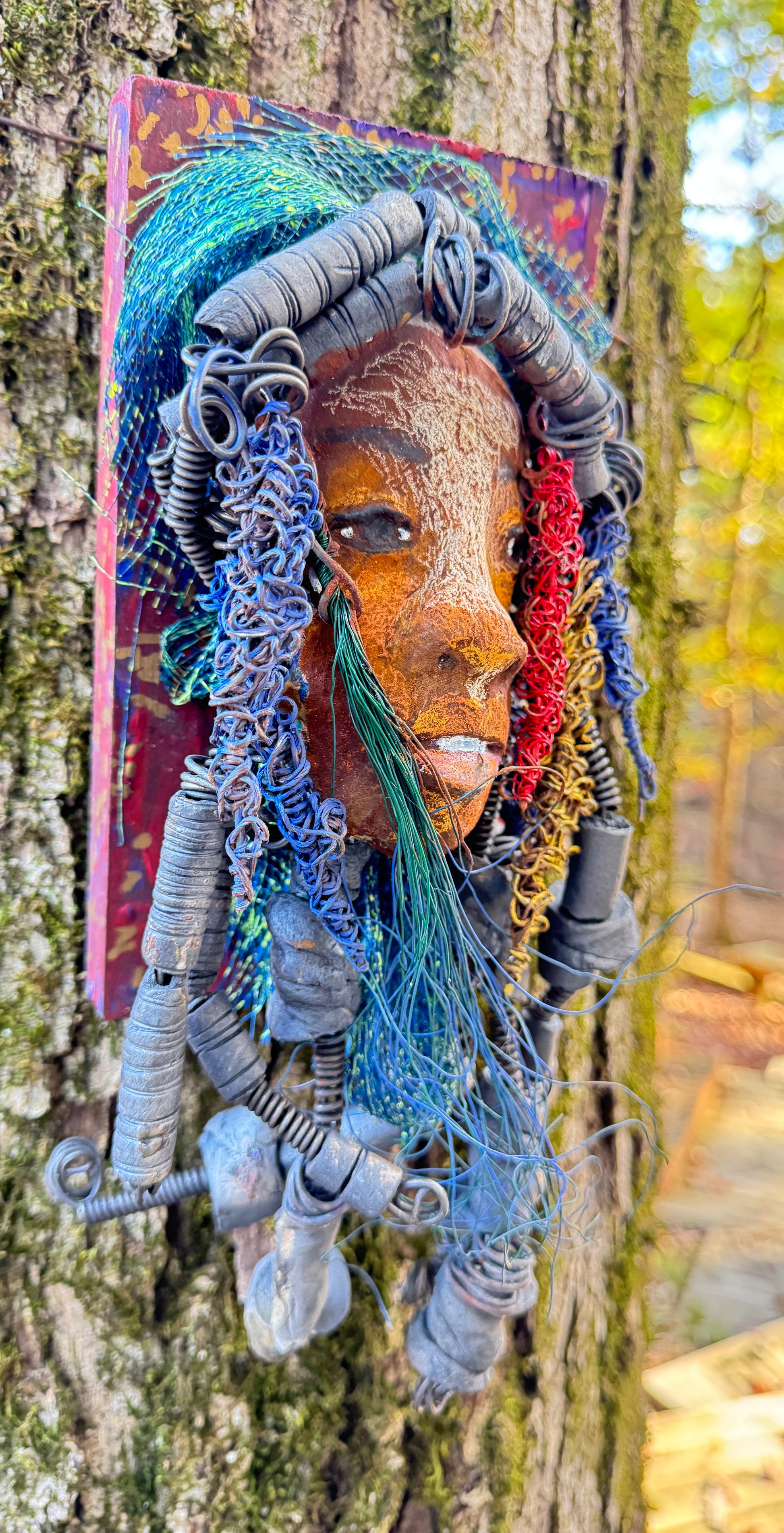 Aamadu is a member of the 2023 range of wooden-mounted tribal masks.
Meet Aamadu, the one-of-a-kind ceramic sculpture who'll make you chuckle with his contagious smile! Standing 4.5"x 8"x 1", Aamadu has a lot of fun features, like his speckled face, handmade raku-fired beads, and over 60 feet of twisted wire for hair! Best of all, it takes over two weeks of hard work to bring him to life - so snag him while you still can!
Instant Message or Chat with me.