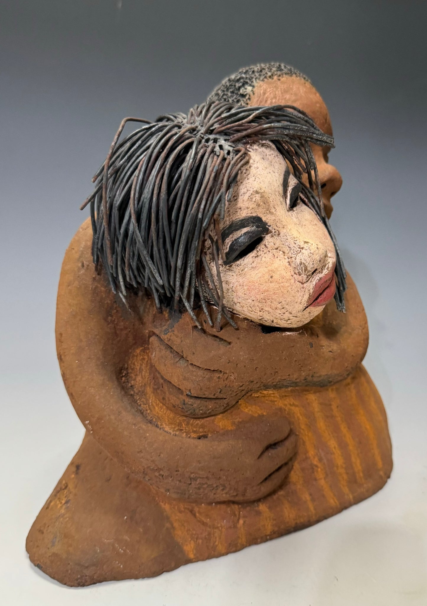What a Sweet Couple... Is she Expecting?! I Love You More stands 10" x 9" x 5" and weighs 5.04 lbs. It has a honey brown complexion, with long loving arms that interlock in affection. Her hair is wire while his is made of clay, making I Love You More unique and perfect for any home.
