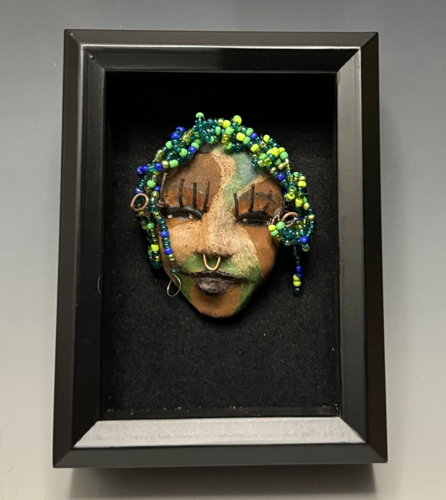 Bailey is a captivating mask, featuring an eye-catching multi-hued hairpiece measuring roughly 4 x 5“ in size and weighing about 7 oz. The mask is further adorned with a copper nose ring and incredibly long eyelashes, and its countenance features three distinct tones for a fetching effect.