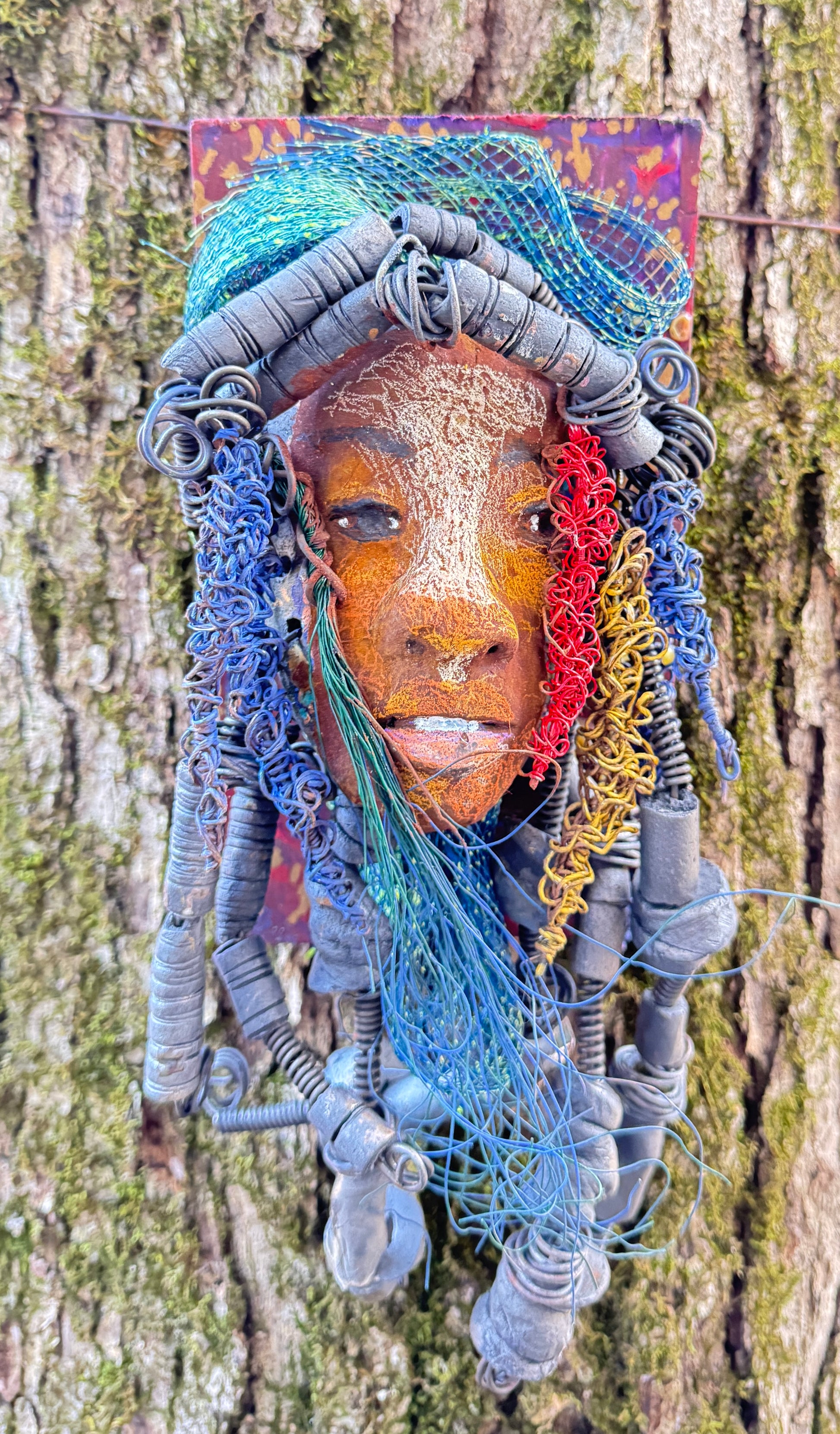 Aamadu is a member of the 2023 range of wooden-mounted tribal masks.
Meet Aamadu, the one-of-a-kind ceramic sculpture who'll make you chuckle with his contagious smile! Standing 4.5"x 8"x 1", Aamadu has a lot of fun features, like his speckled face, handmade raku-fired beads, and over 60 feet of twisted wire for hair! Best of all, it takes over two weeks of hard work to bring him to life - so snag him while you still can!
Instant Message or Chat with me.
