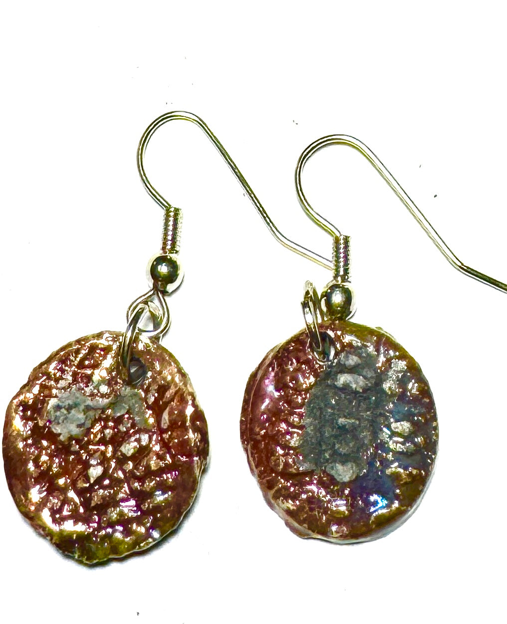 Raku Fired Earrings Shimmery Copper Luster Glazed on both sides 1/2 ounce The Raku Fired Earrings have a unique copper luster glaze that adds a special touch to any outfit. They come in a convenient 1/2 ounce pack, so you can easily take them on the go.