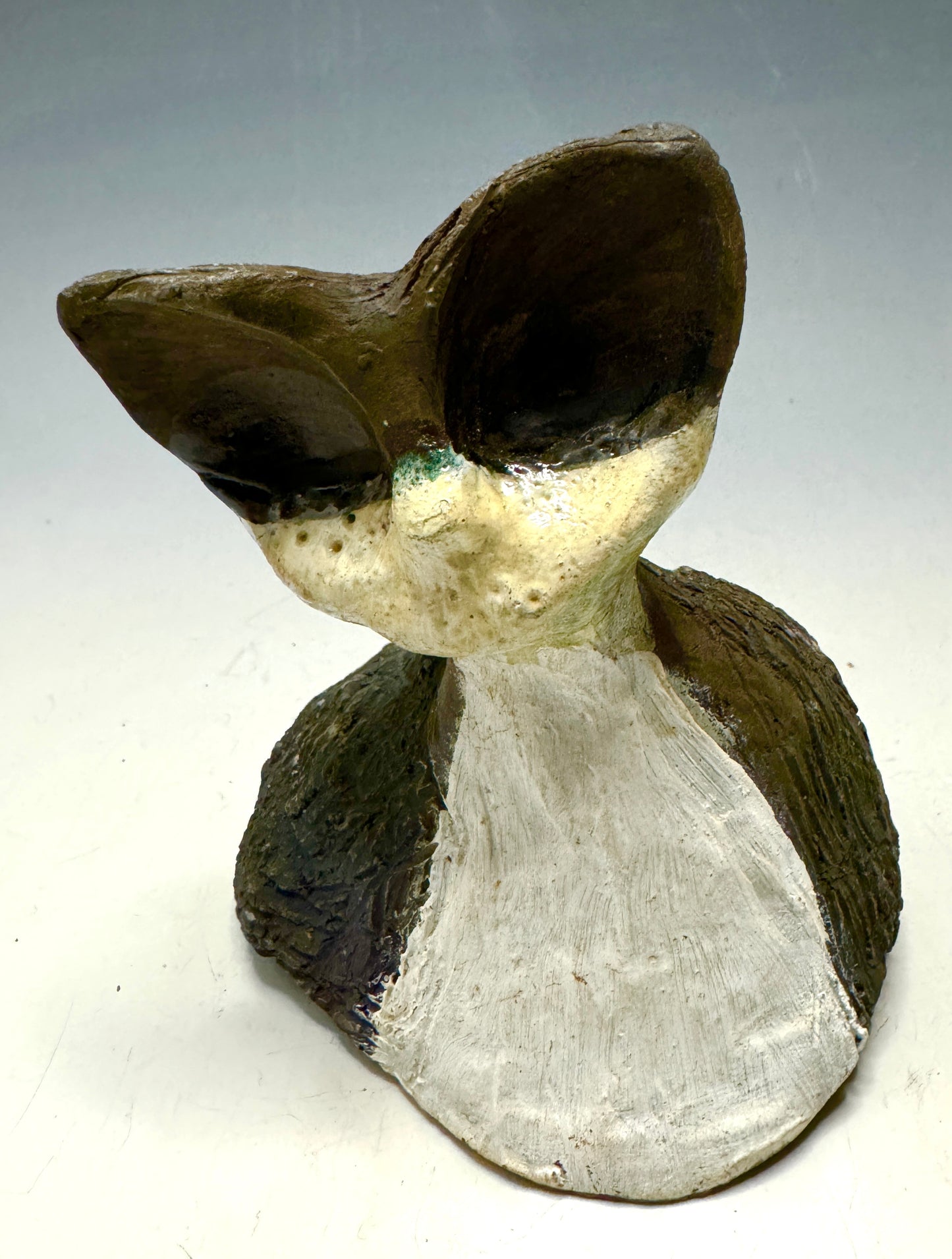 She's a pet with major big head 4" x 4" x 3 " personality! This tiny wonder packs a powerful punch, boasting a stunning metallic patina and a lightweight design. Let her bring joy to any room with her endearing kitty cheer - she's sure to win your heart!