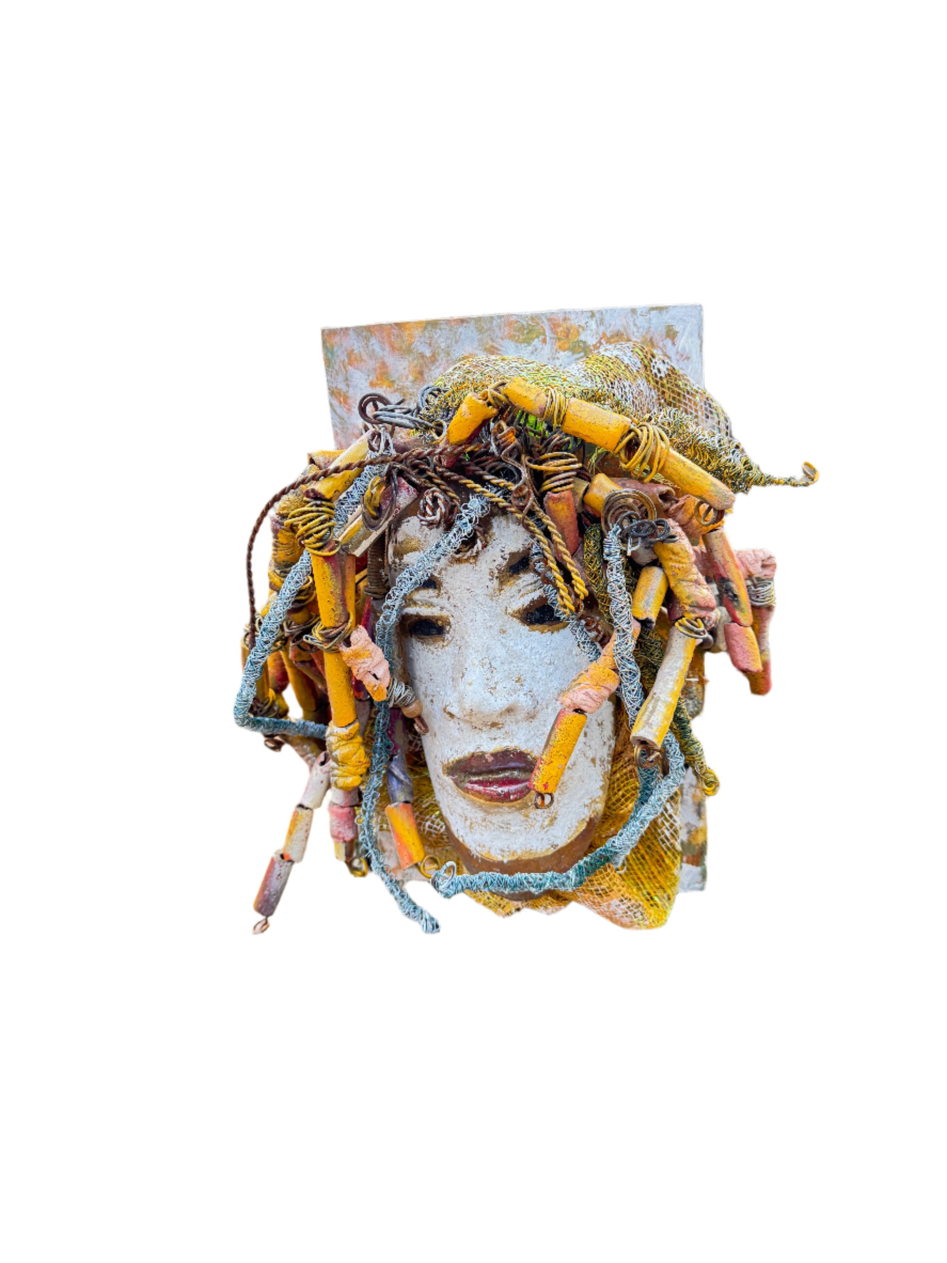Experience the unique beauty of Amos, a mixed media raku fire mask carefully crafted with over 50 handmade beads and 50 feet of 24 and 16 gauge wire. Mounted on a 7” x 12” wood board and weighing approximately 4 pounds, Amos features an off-white face with braided and beaded  hair. This one-of-a-kind masterpiece also includes several fabrics of netting in his hair, making it larger than most masks.