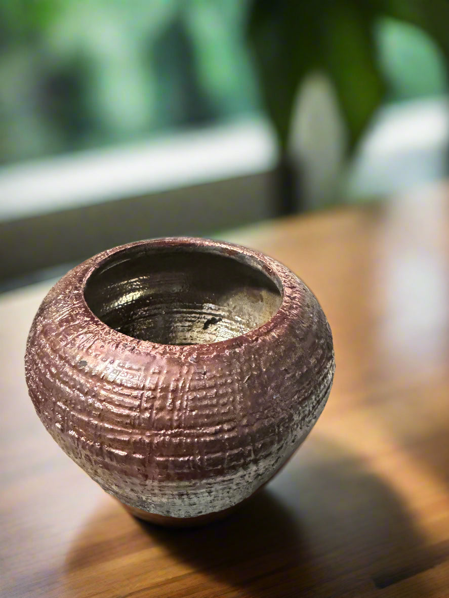 Add natural beauty to any space with the Earthy Vase with Incense Top -4, featuring an iridescent copper finish. Measuring 4 1/2 inches tall, 4.5 inches wide and deep, and weighing 1 pound and 1 -52 ounces, this vase is perfect for displaying flowers and accents. Its rustic charm is enhanced by the copper glazed interior, and the 3-inch opening allows for easy arranging. The top can also function as an incense holder.