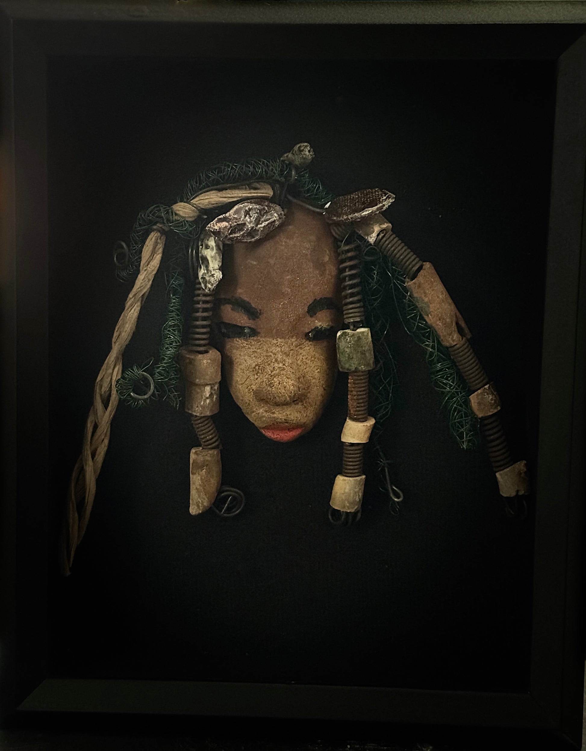 Wanda is a 5" x 8" Raku-fired mask, featuring 16 and 24-gauge wire over 20ft in length. Her two tone honey brown complexion is the perfect contrast to her green-coiled locs. Get her this holiday season at a discount, making it the perfect time to start a collection or gift her as a special surprise. She look great in a shadow box, on a tree, or just standing alone.