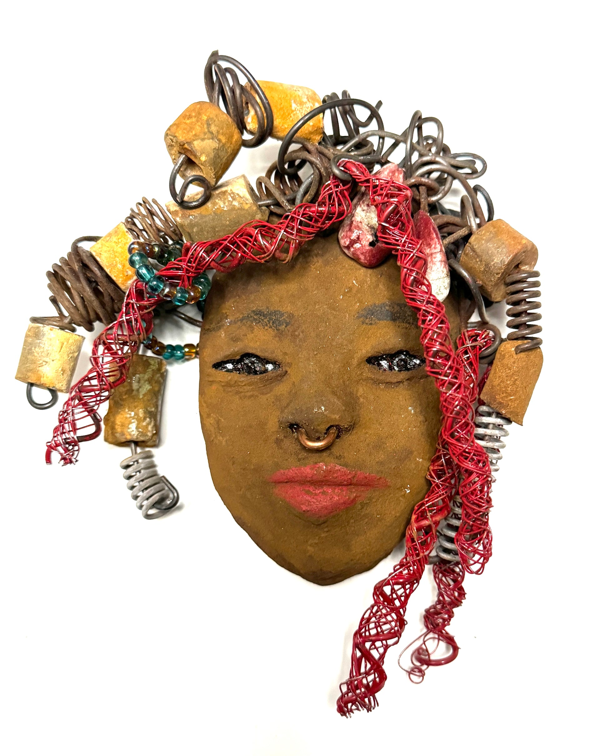 At 5" x 6" in size, Ola makes a stunning addition to walls, trees, and shadow boxes. His signature red braided hair is ornamented with handcrafted Raku beads, while his skin has a warm honey brown hue. Each piece is equipped with over 20 feet of top-notch 16 & 24-gauge wire in the hair. This fashionable sculpture will bring a modern flair to any room - simply place it in a shadow box and enjoy!