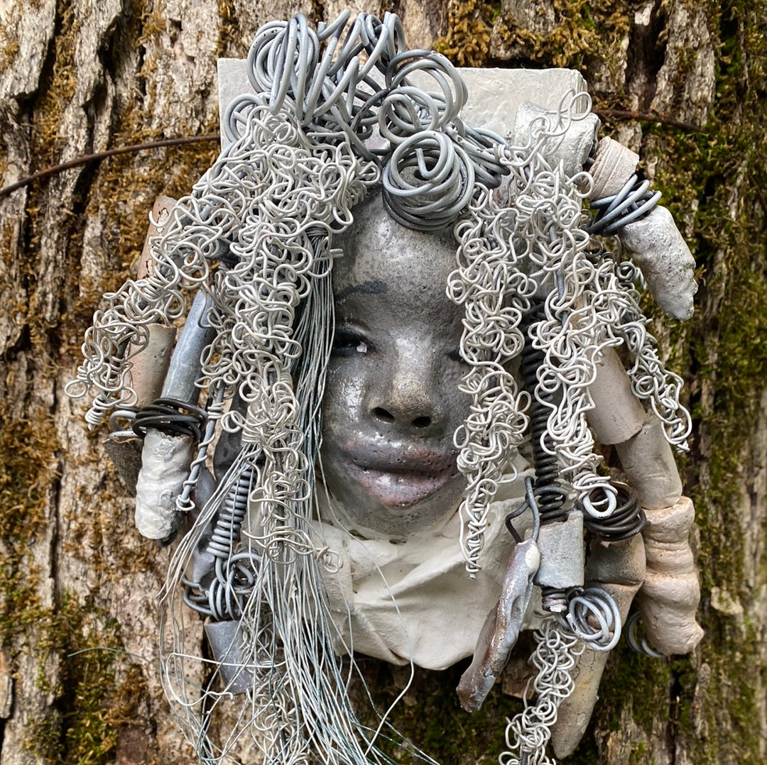 Winter is mounted on a 5"x 6" painted wood canvas. I spent about 4 hours or more just fixing her hair and attaching beads! Winter has over 100 feet of 16 and 24 gauge wire for hair. Winter has a white crackle face with dark reddish gray lips. She weighs 2 lbs and is ready to be hung! Got Questions????