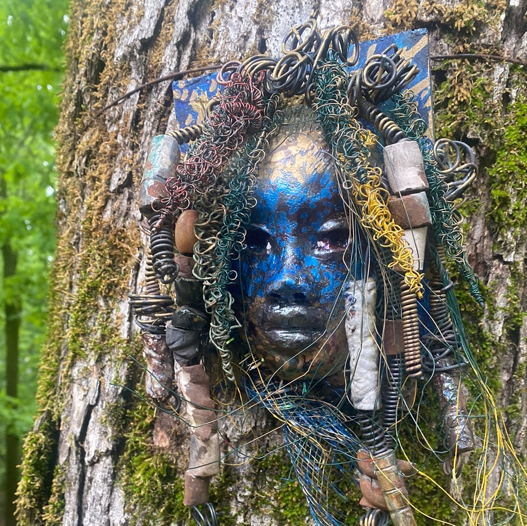 Urbi is one of a new 2023 series of tribal masks that are mounted on wood.