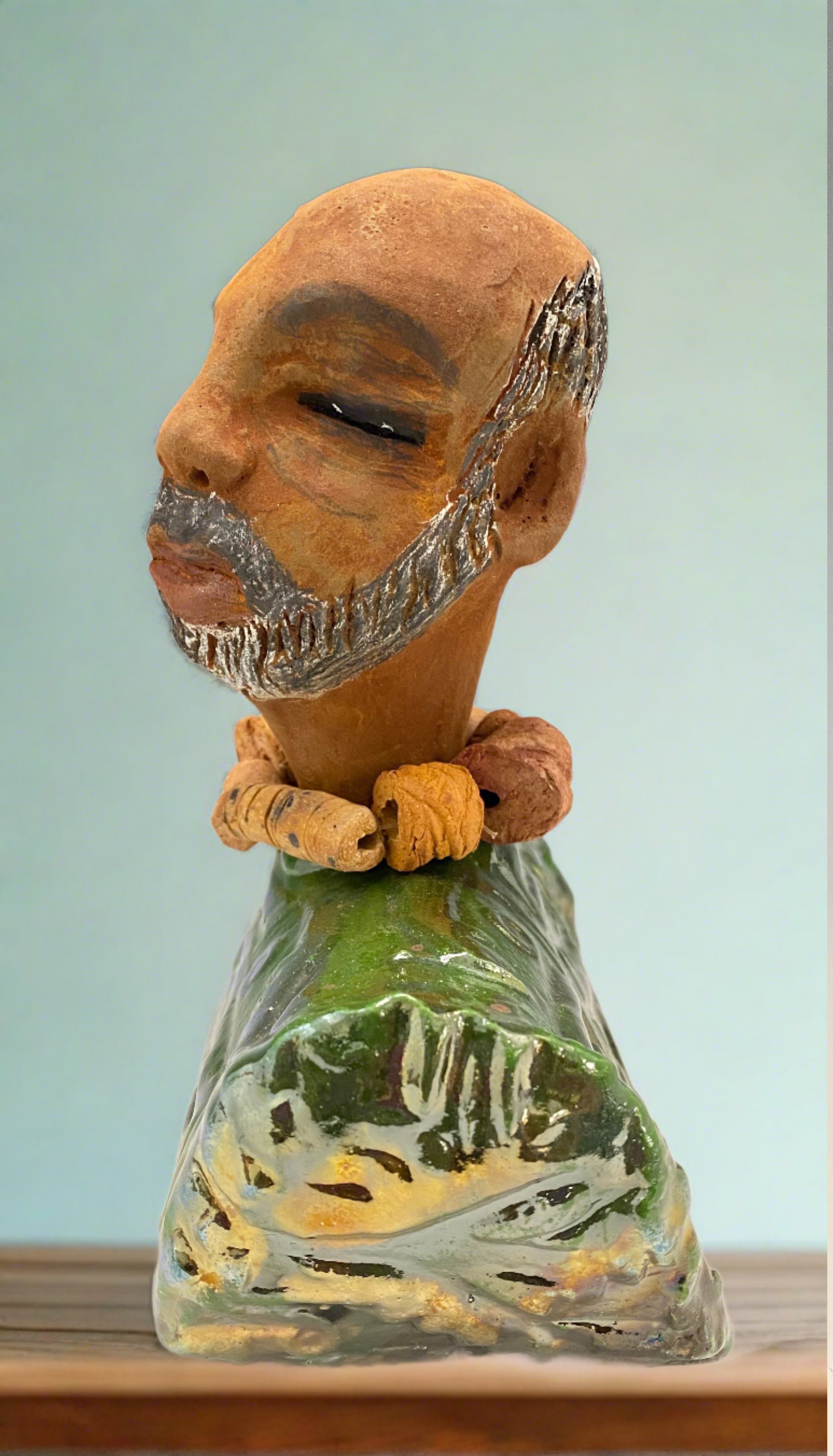 Albert measures 7.5" x 6" x 3" and weights 2.5lbs.<br>He is dressed in a metallic copper green dashiki.<br>He is partially bald, sporting a salt and peppered beard.<br>He is unique within the Herdew collection! Albert is the perfect size and weight for easy portability. His stylish outfit ensures he always stands out in the crowd. He's sure to be the talk of your collection!
