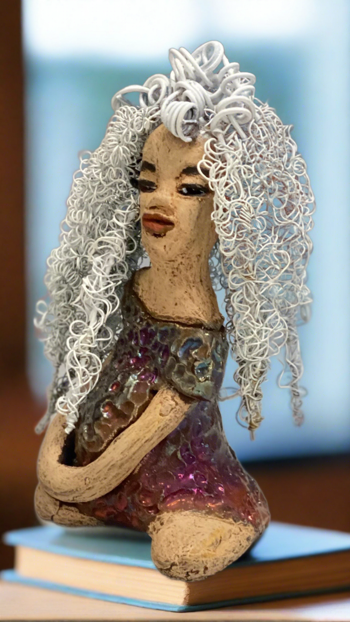 Alyssa stands 6" x 5" x 5" and weighs 12 ozs. She has a lovely honey brown complexion with cocoa brown lips. She has long twisted white wire locs hairstyle waist down! Alyssa has a metallic copper antique glazed dress. She has over 75 feet of 16 and 24 gauge white wire for hair. It took over 3 hours just to do her hair! With eyes wide opened, Brianna has hope of finding a new home. You will love having Alyssa. She will attract and spark conversation with guest in your home!