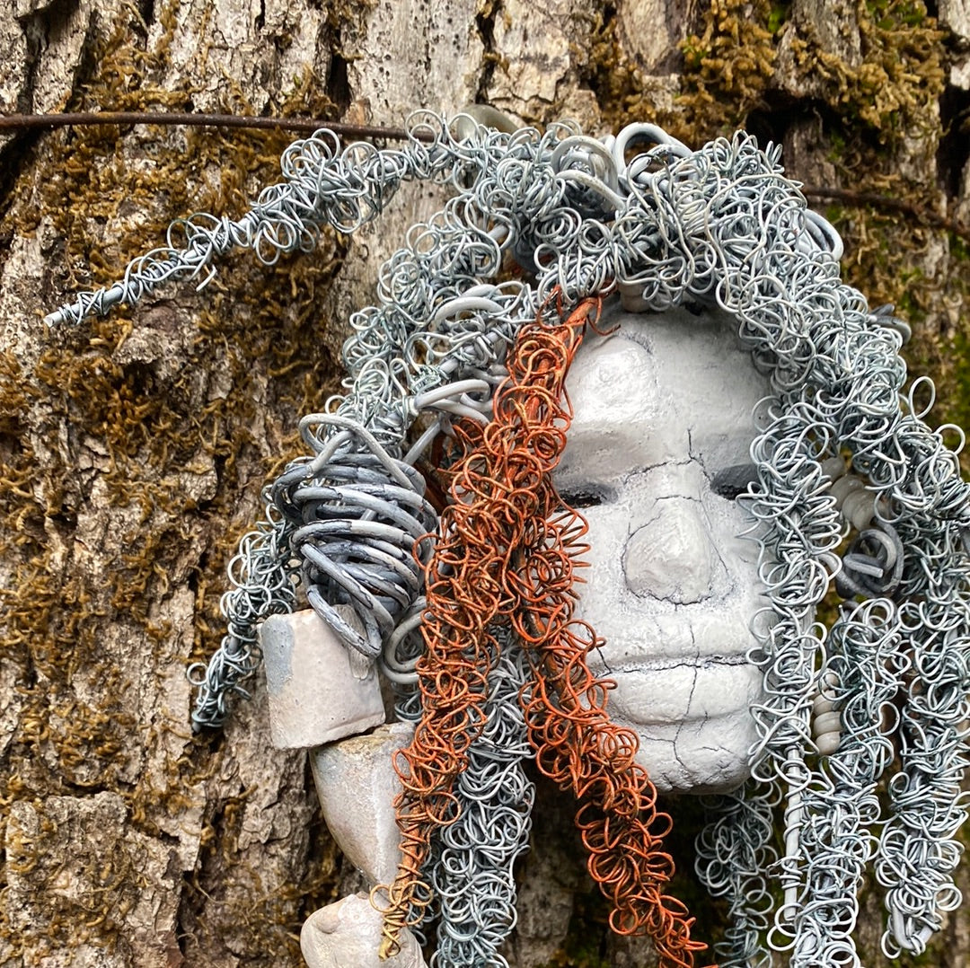 Wendy has an off white complexion with off white lips. She is 6”x 8” and weighs 10 ozs. Wendy has handmade raku fired beads. Wendy has over 70 feet of coiled 24 and 16 gauge wire hair.