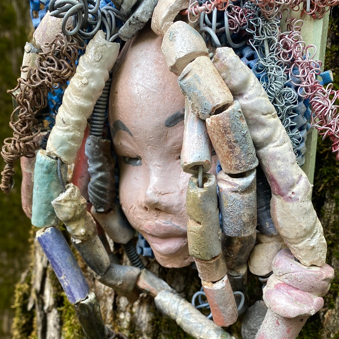 Zaire is mounted on a 5"x 6" painted wood canvas. I spent about 4 hours or more just fixing her hair and attaching beads! Zaire has over 100 feet of 16 and 24 gauge wire for hair. Zaire has a white crackle face with dark gray lips. She weighs 2.10 lbs and is ready to be hung!