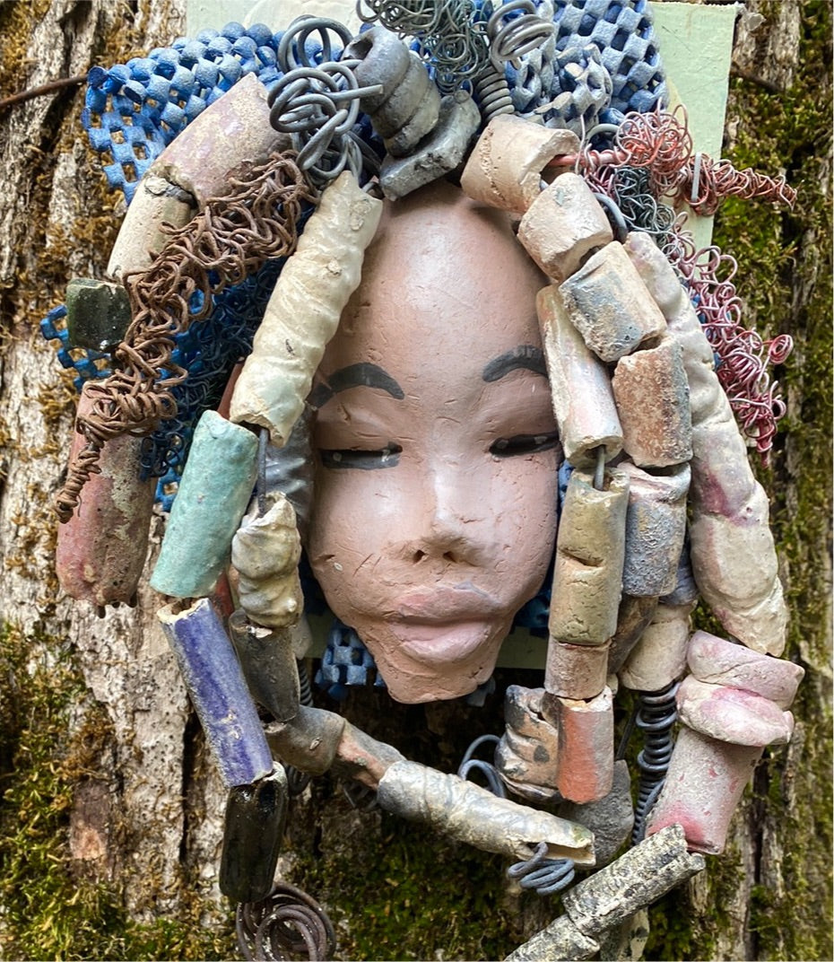 Zaire is mounted on a 5"x 6" painted wood canvas. I spent about 4 hours or more just fixing her hair and attaching beads! Zaire has over 100 feet of 16 and 24 gauge wire for hair. Zaire has a white crackle face with dark gray lips. She weighs 2.10 lbs and is ready to be hung!