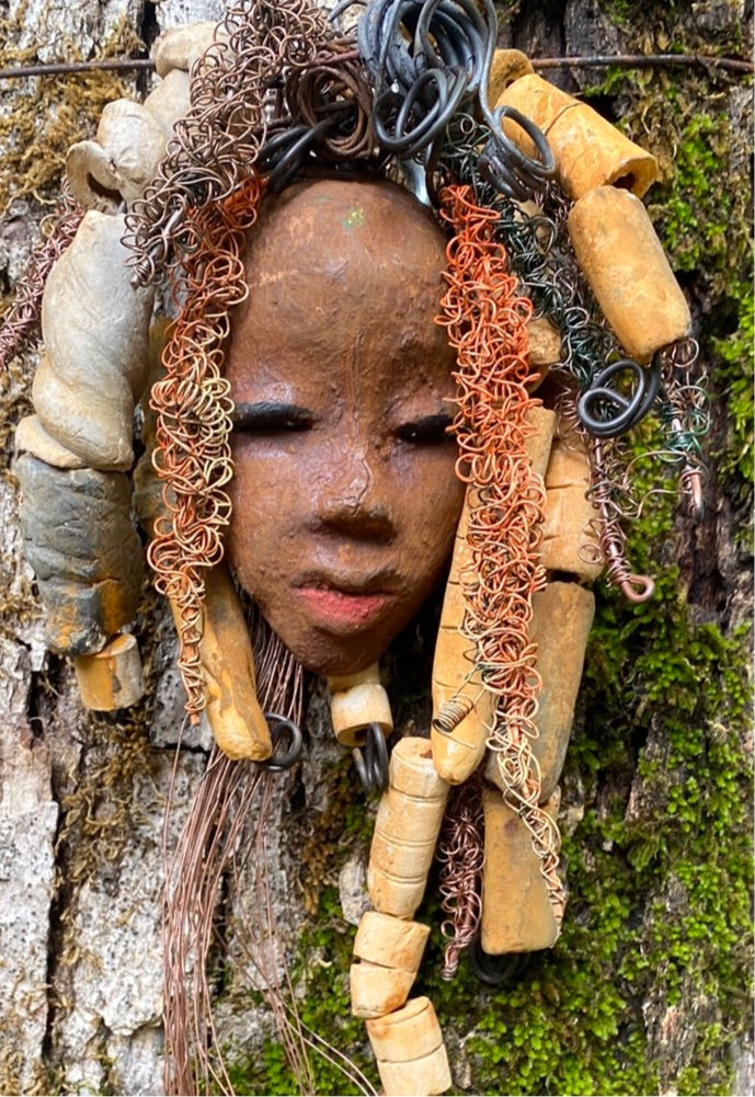 Yembe is 4”x6 ” and weighs 7ozs. She has a brown complexion. Yembe has big hair with several spiral coils handmade Raku beads. Over 30 ft of hand twisted 16 and 24 gauge wire!