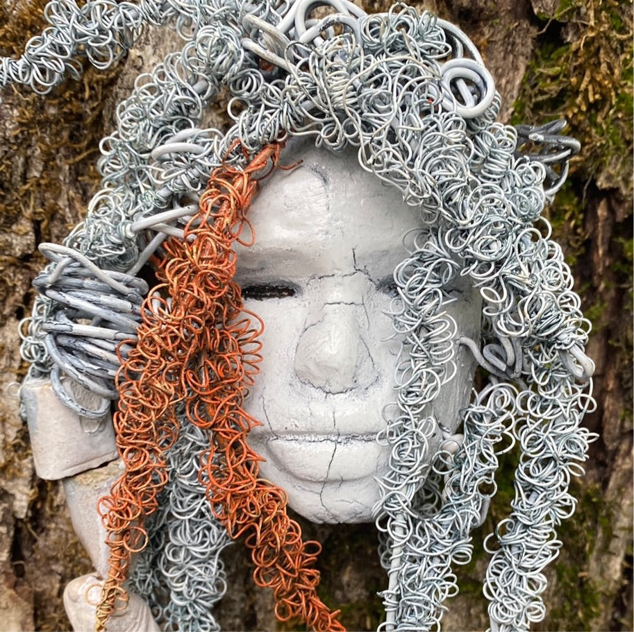 Wendy has an off white complexion with off white lips. She is 6”x 8” and weighs 10 ozs. Wendy has handmade raku fired beads. Wendy has over 70 feet of coiled 24 and 16 gauge wire hair.