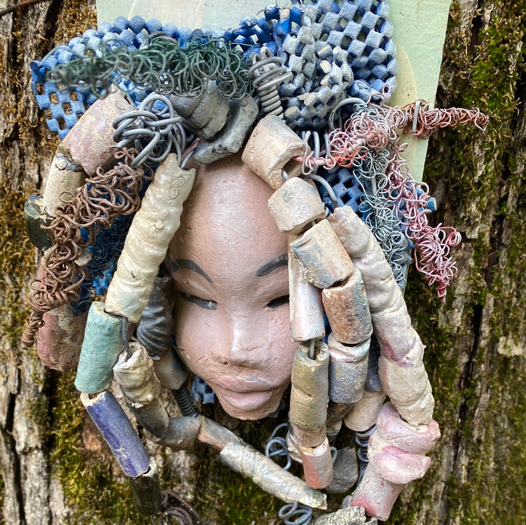 Zaire is mounted on a 5"x 6" painted wood canvas. I spent about 4 hours or more just fixing her hair and attaching beads! Zaire has over 100 feet of 16 and 24 gauge wire for hair. Zaire has a white crackle face with dark gray lips. She weighs 2.10 lbs and is ready to be hung!