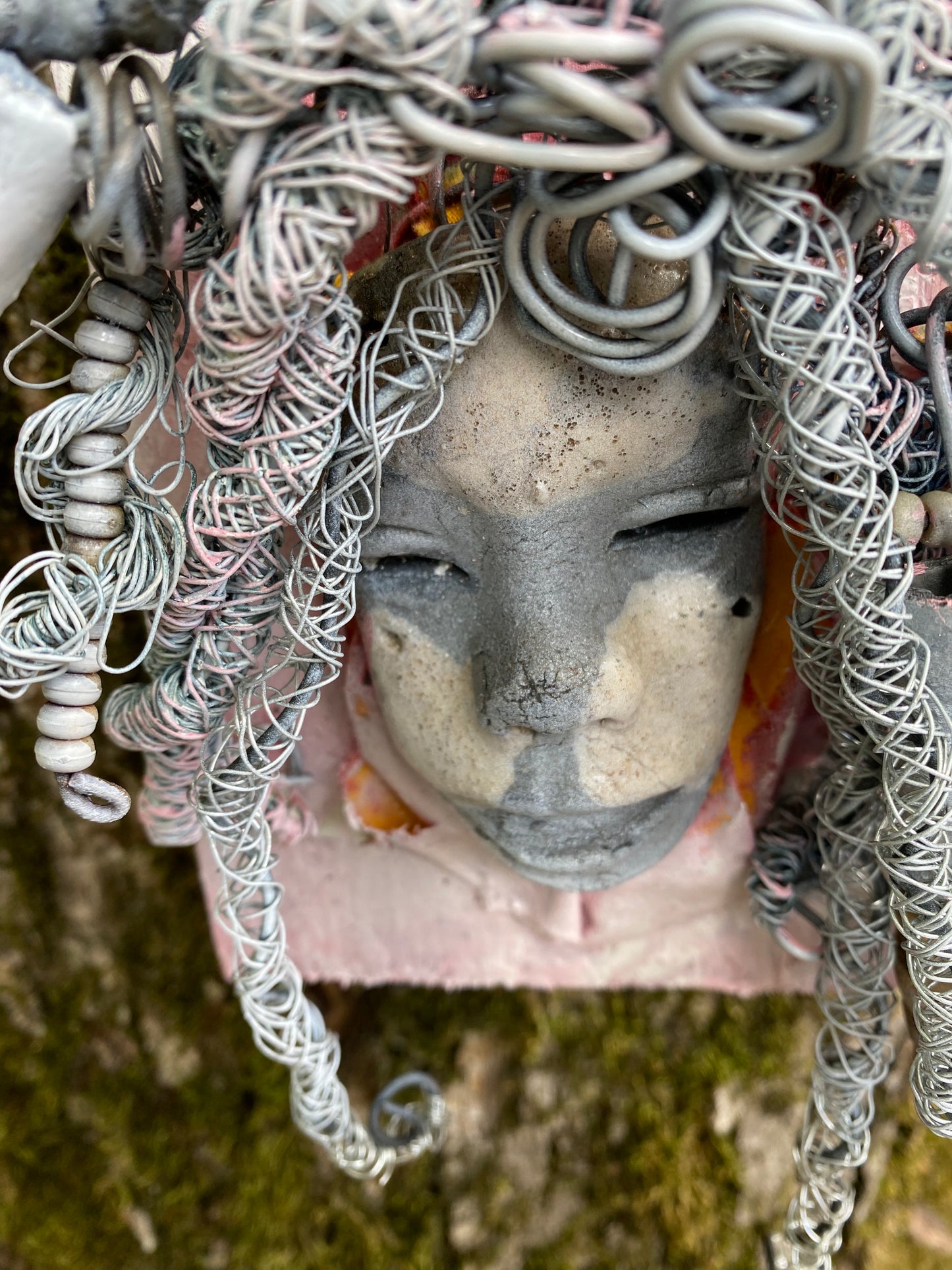 Bring a bit of quirk to your walls with Venice! This one-of-a-kind folk art piece is mounted on a painted 5”x 6” wood canvas and features over 40 feet of wired hair and Raku beads! With white , antique crackle face and lips, she is sure to liven up any space. Whether you want a conversation starter or just an eye-catching piece of art, Venice is ready to be hung! Got questions? Just ask!Got Questions??