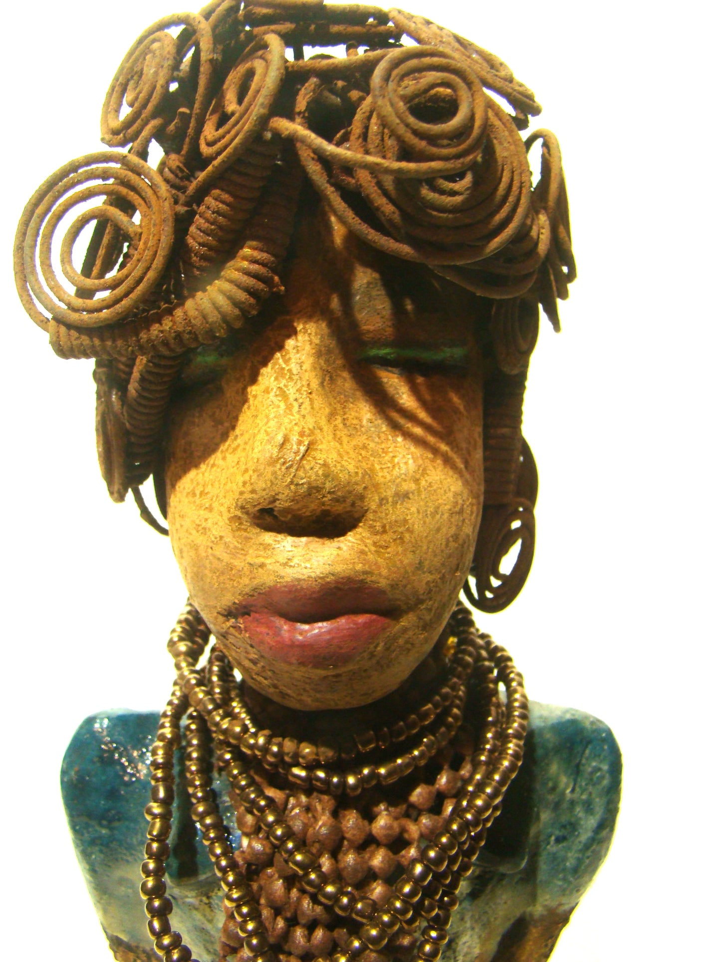 Sherri stands 13' x 4" x 2.5" and weighs 3.05 lbs. She has over 25 feet of wire curls and coils. Sherri has a sweet honey brown complexion. Her dress is a metallic multi colored green with an amber beaded necklace and scarf. Sherri has the familiar long loving arms at her side.