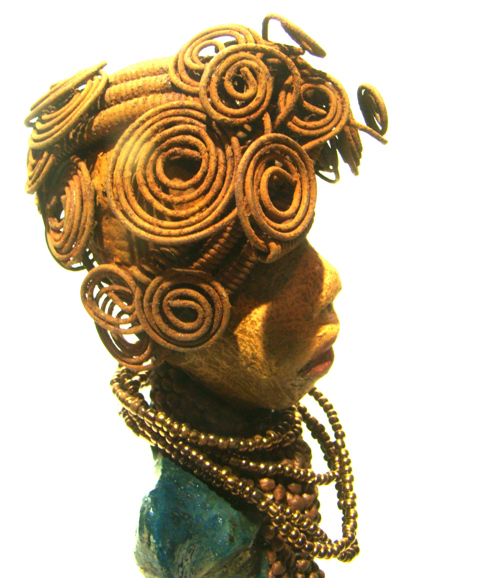 Sherri stands 13' x 4" x 2.5" and weighs 3.05 lbs.     She has over 25 feet of wire curls and coils.     Sherri has a sweet honey brown complexion.     Her dress is a metallic multi colored green with an amber beaded necklace and scarf.     Sherri has the familiar long loving arms at her side.