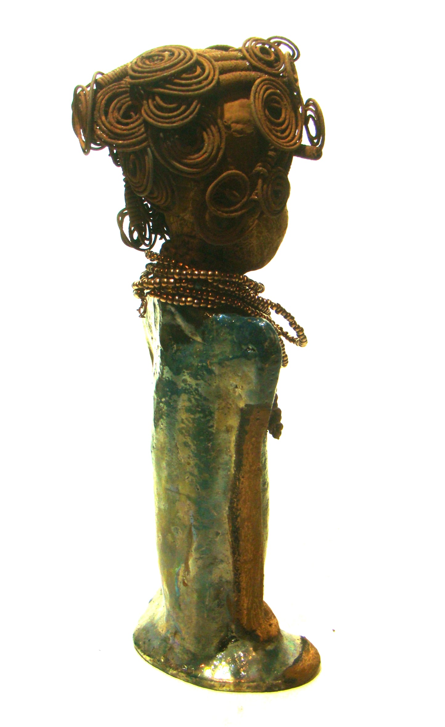 Sherri stands 13' x 4" x 2.5" and weighs 3.05 lbs. She has over 25 feet of wire curls and coils. Sherri has a sweet honey brown complexion. Her dress is a metallic multi colored green with an amber beaded necklace and scarf. Sherri has the familiar long loving arms at her side.