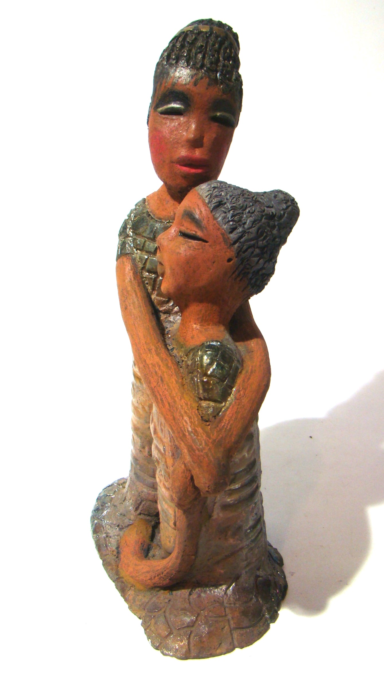 Girl Talk with my Mom stands 13' x 7" x 4" and weighs 14.lbs. They were raku fired etched metallic copper dresses. Their hair is made of clay and raised into an etched bun. They have lovely honey brown complexions and long loving arms. Girl Talk with my Mom would remind one of those special moments in tim