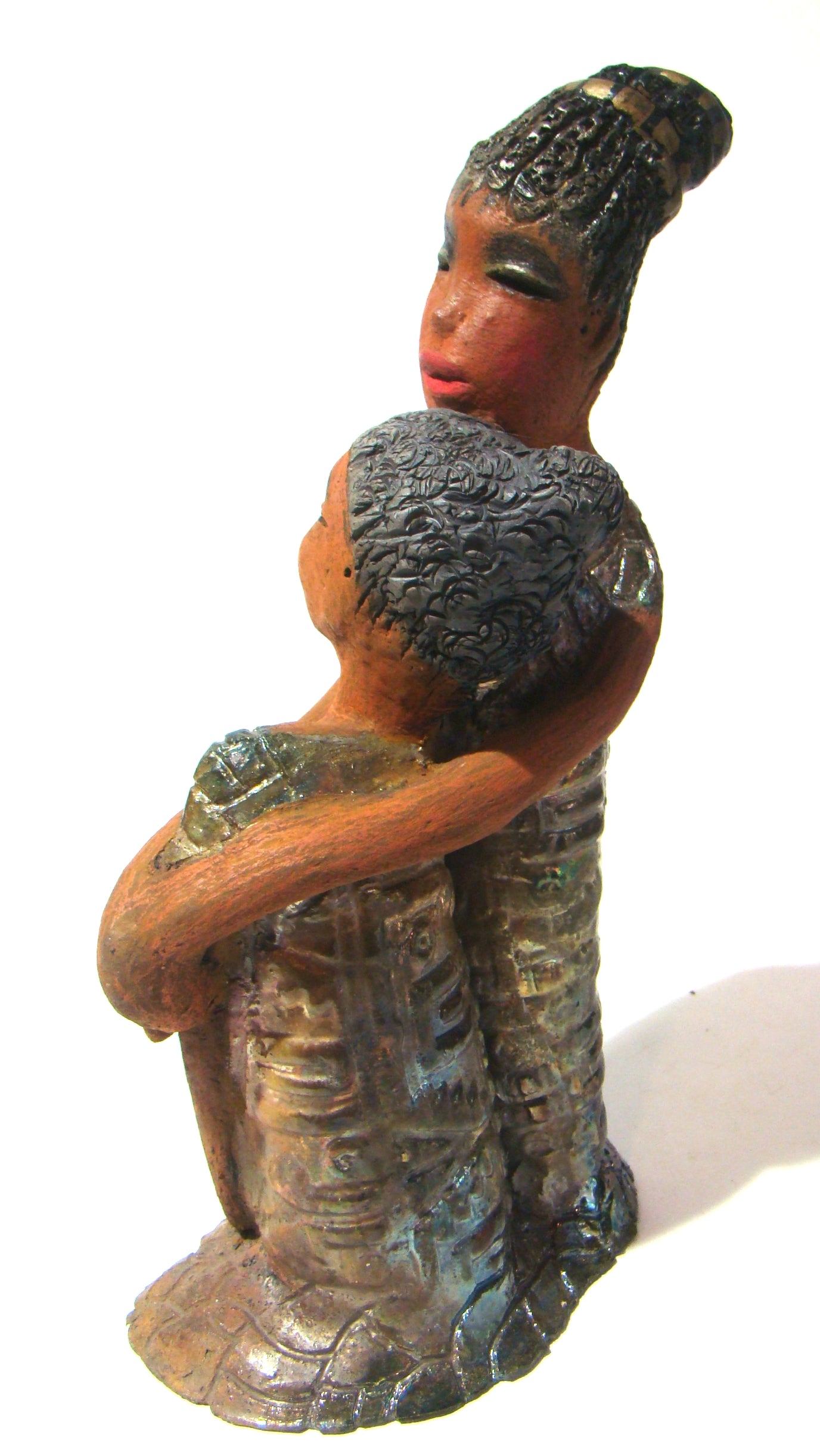 Girl Talk with my Mom stands 13' x 7" x 4" and weighs 14.lbs. They were raku fired etched metallic copper dresses. Their hair is made of clay and raised into an etched bun. They have lovely honey brown complexions and long loving arms. Girl Talk with my Mom would remind one of those special moments in tim